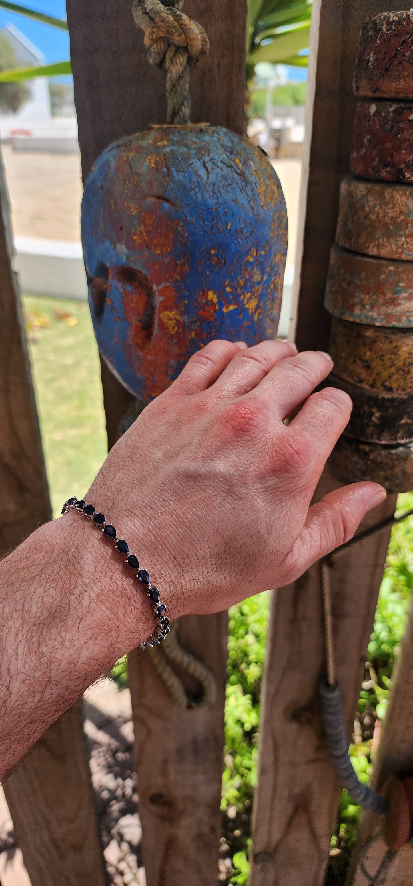 Breathtakingly beautiful sterling silver tennis bracelet, shimmering with 25 pear-cut deep-blue sapphires.
