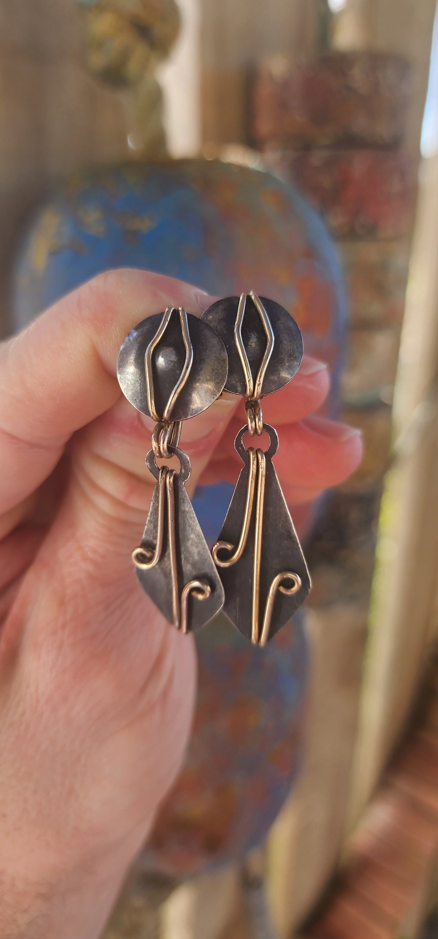 A spectacular Arts & Crafts era treasure (c. 1900s) — this generous, hand-wrought pair of clip-on drop earrings perfectly captures the raw spirit and bold design language of early artisan metalwork.
