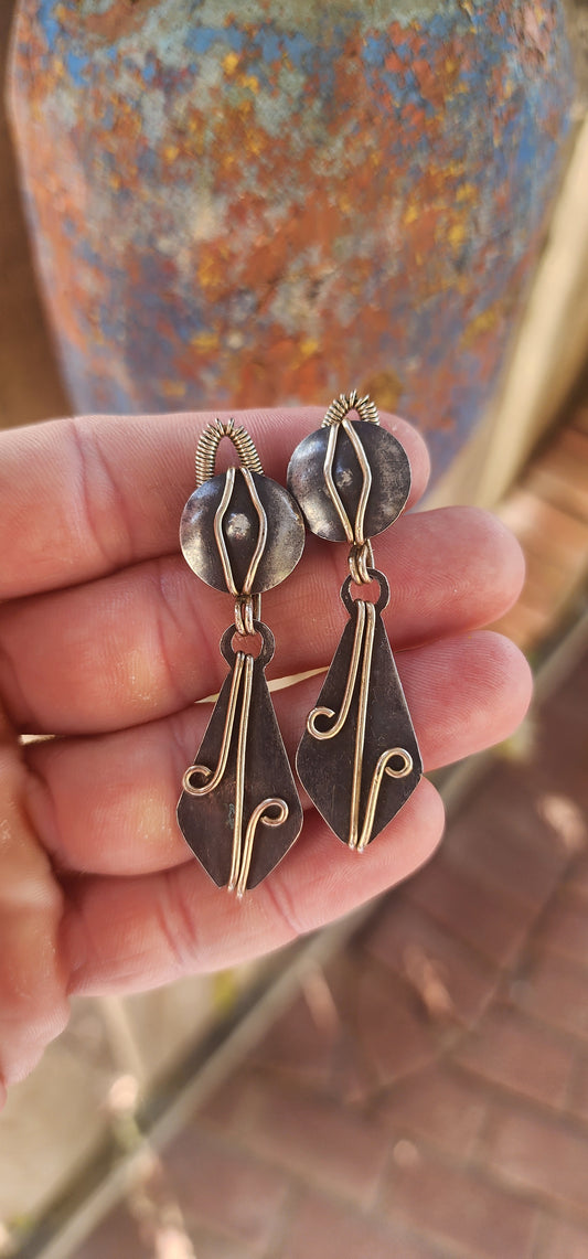 A spectacular Arts & Crafts era treasure (c. 1900s) — this generous, hand-wrought pair of clip-on drop earrings perfectly captures the raw spirit and bold design language of early artisan metalwork.