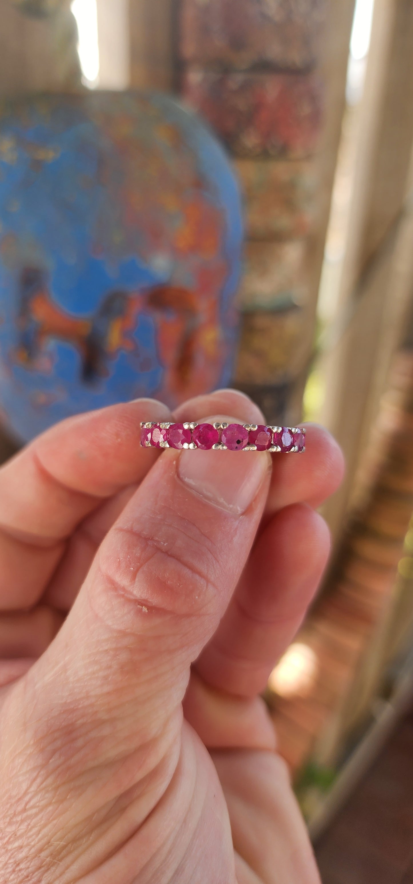 This sterling silver full eternity ring is a true showstopper—crafted with precision and designed to dazzle from every angle. A continuous circle of rich, round-cut rubies is prong-set all the way around.