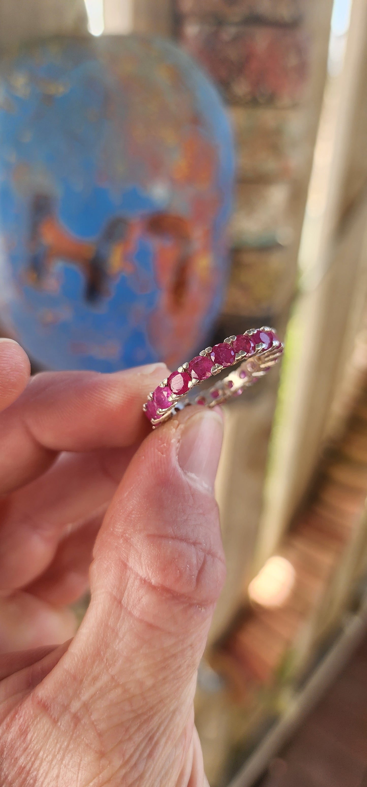 This sterling silver full eternity ring is a true showstopper—crafted with precision and designed to dazzle from every angle. A continuous circle of rich, round-cut rubies is prong-set all the way around.