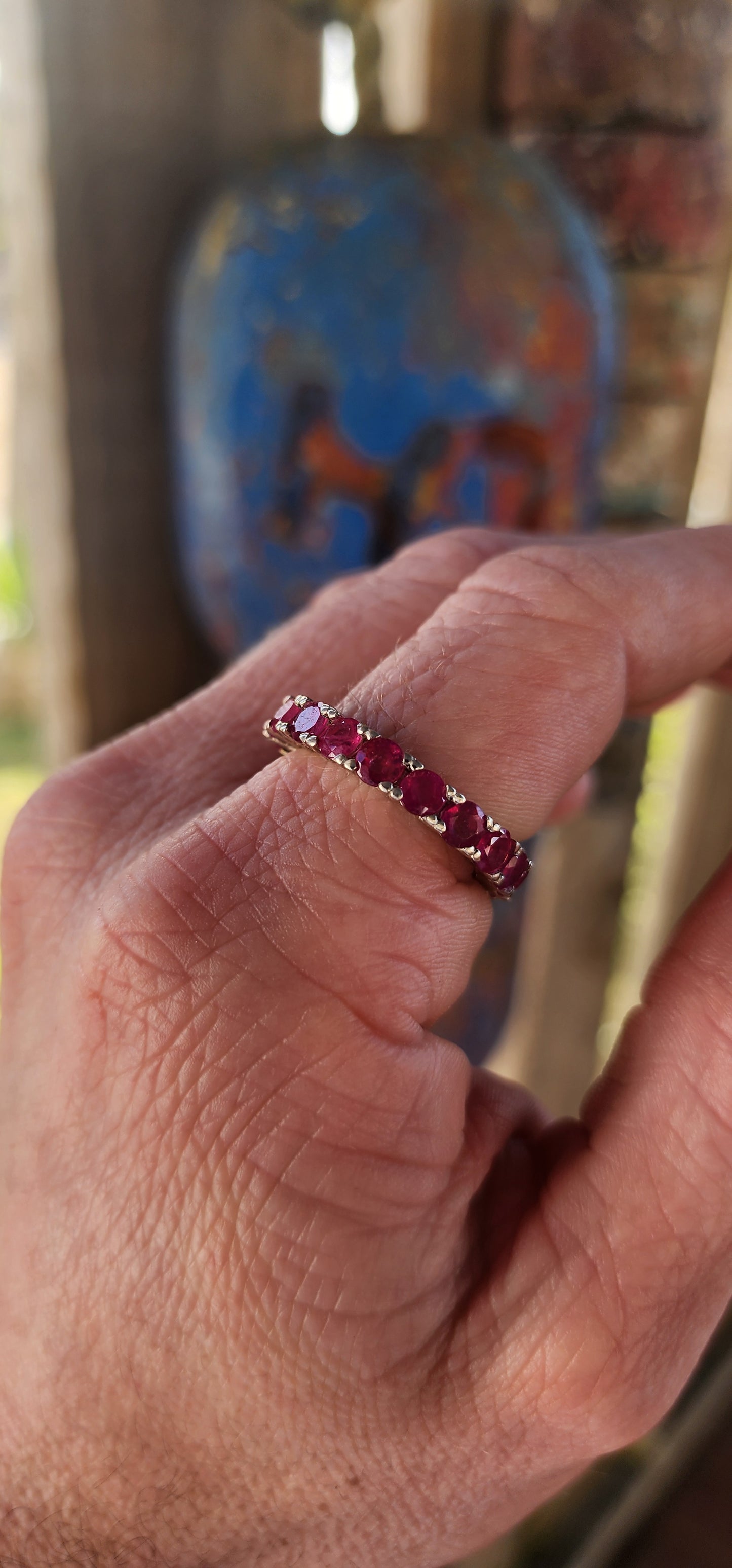 This sterling silver full eternity ring is a true showstopper—crafted with precision and designed to dazzle from every angle. A continuous circle of rich, round-cut rubies is prong-set all the way around.