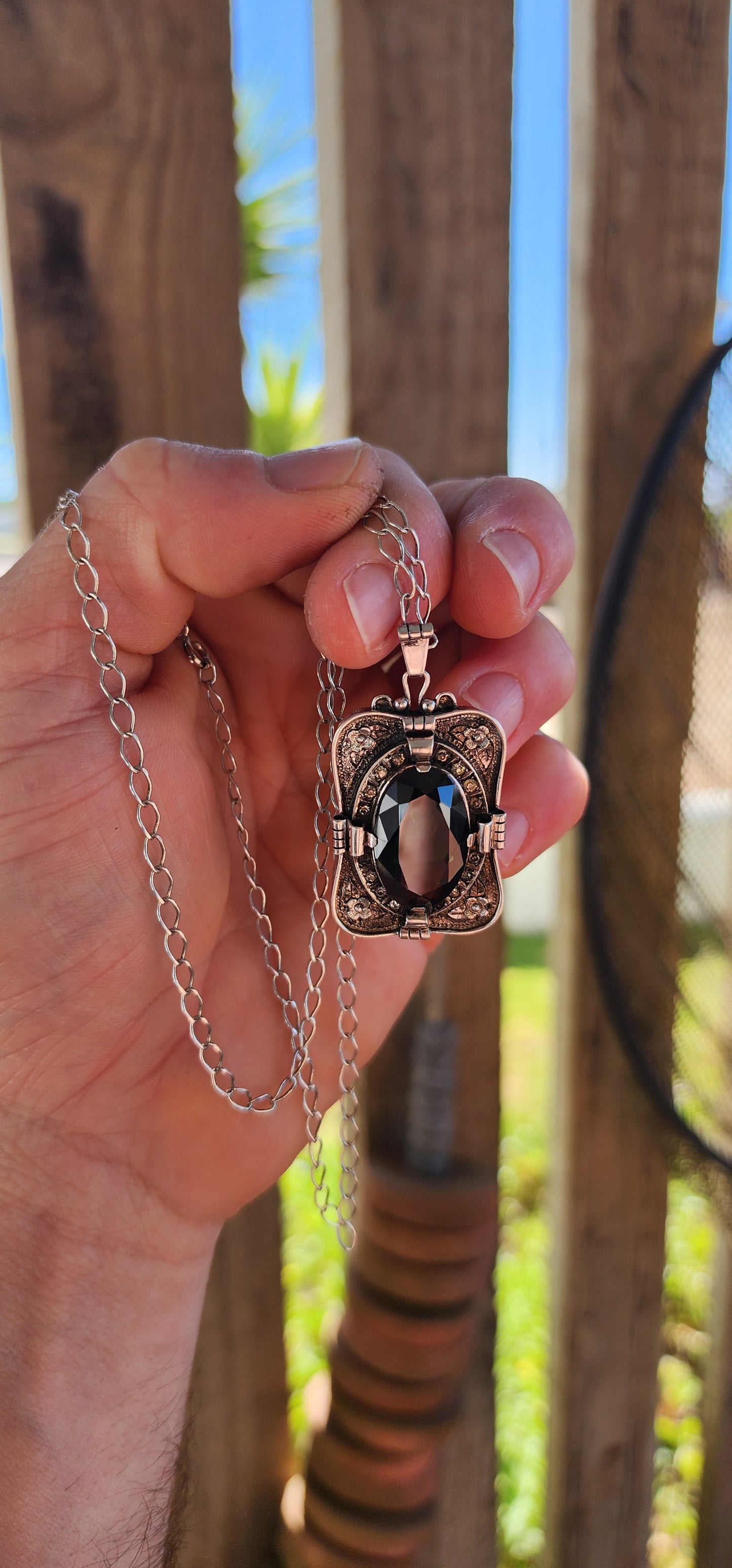 A magnificent step-back into the golden age of glamour, this rare and generous Art Deco pendant is a true showpiece—richly detailed, architecturally sculpted, and brimming with Old-World mystique.
