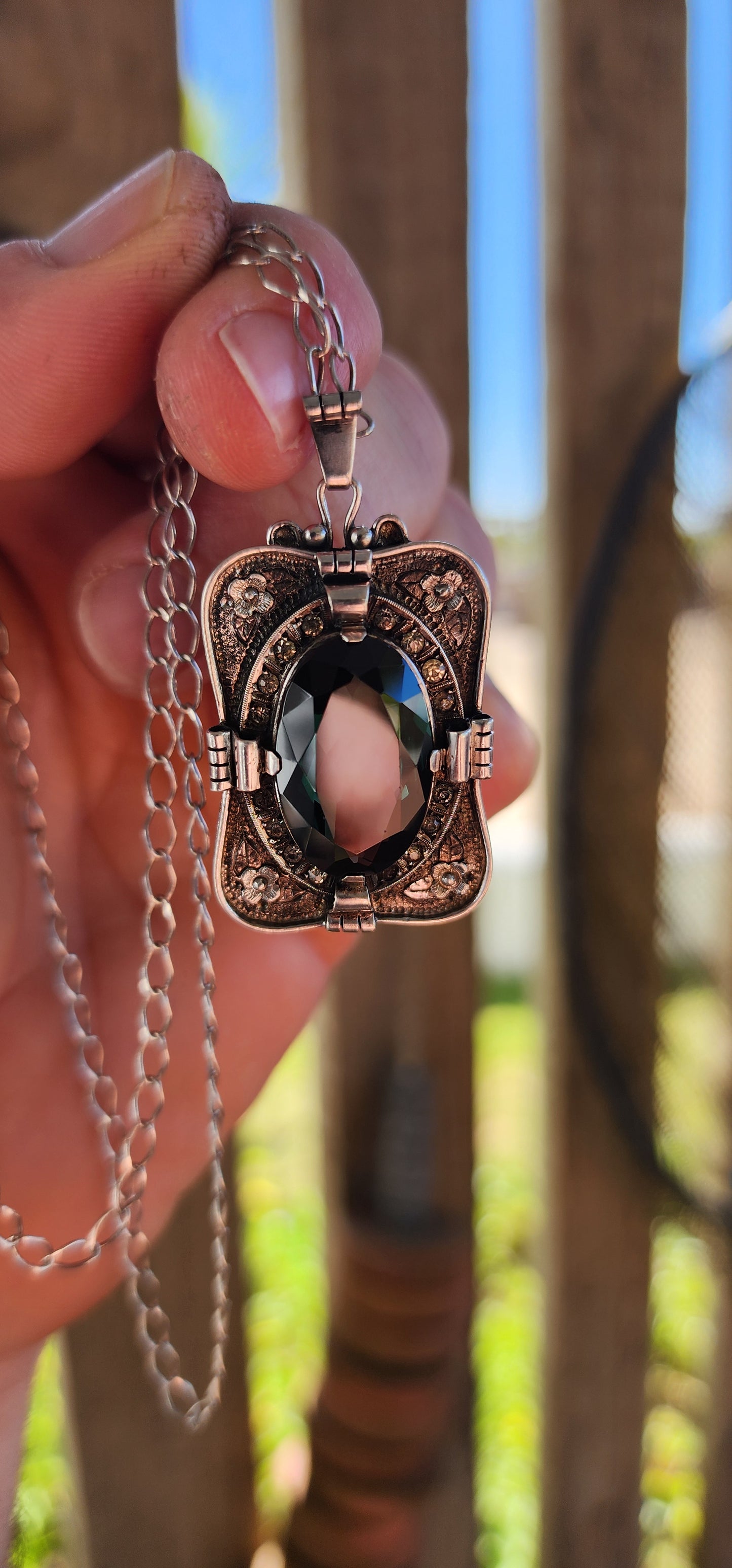 A magnificent step-back into the golden age of glamour, this rare and generous Art Deco pendant is a true showpiece—richly detailed, architecturally sculpted, and brimming with Old-World mystique.