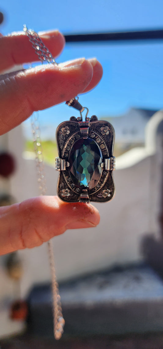A magnificent step-back into the golden age of glamour, this rare and generous Art Deco pendant is a true showpiece—richly detailed, architecturally sculpted, and brimming with Old-World mystique.