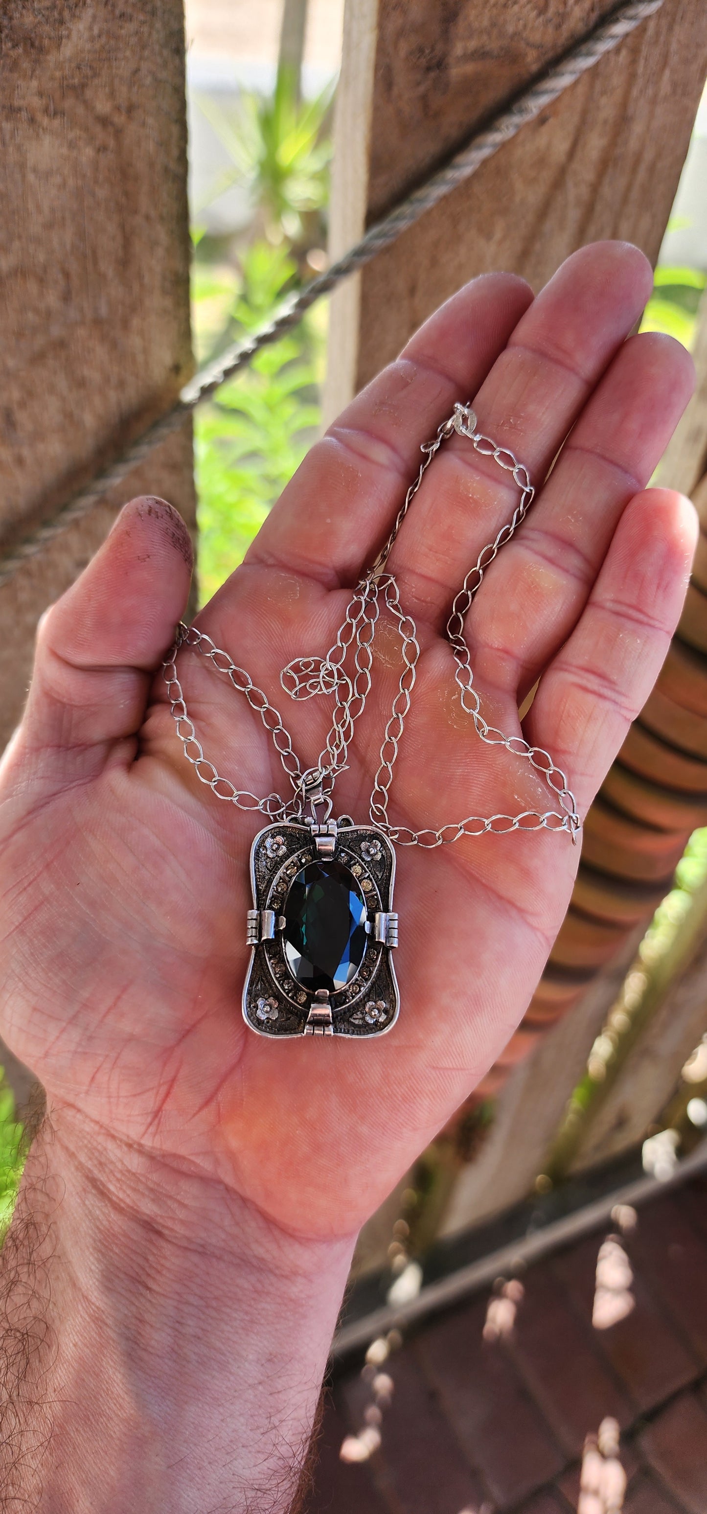 A magnificent step-back into the golden age of glamour, this rare and generous Art Deco pendant is a true showpiece—richly detailed, architecturally sculpted, and brimming with Old-World mystique.