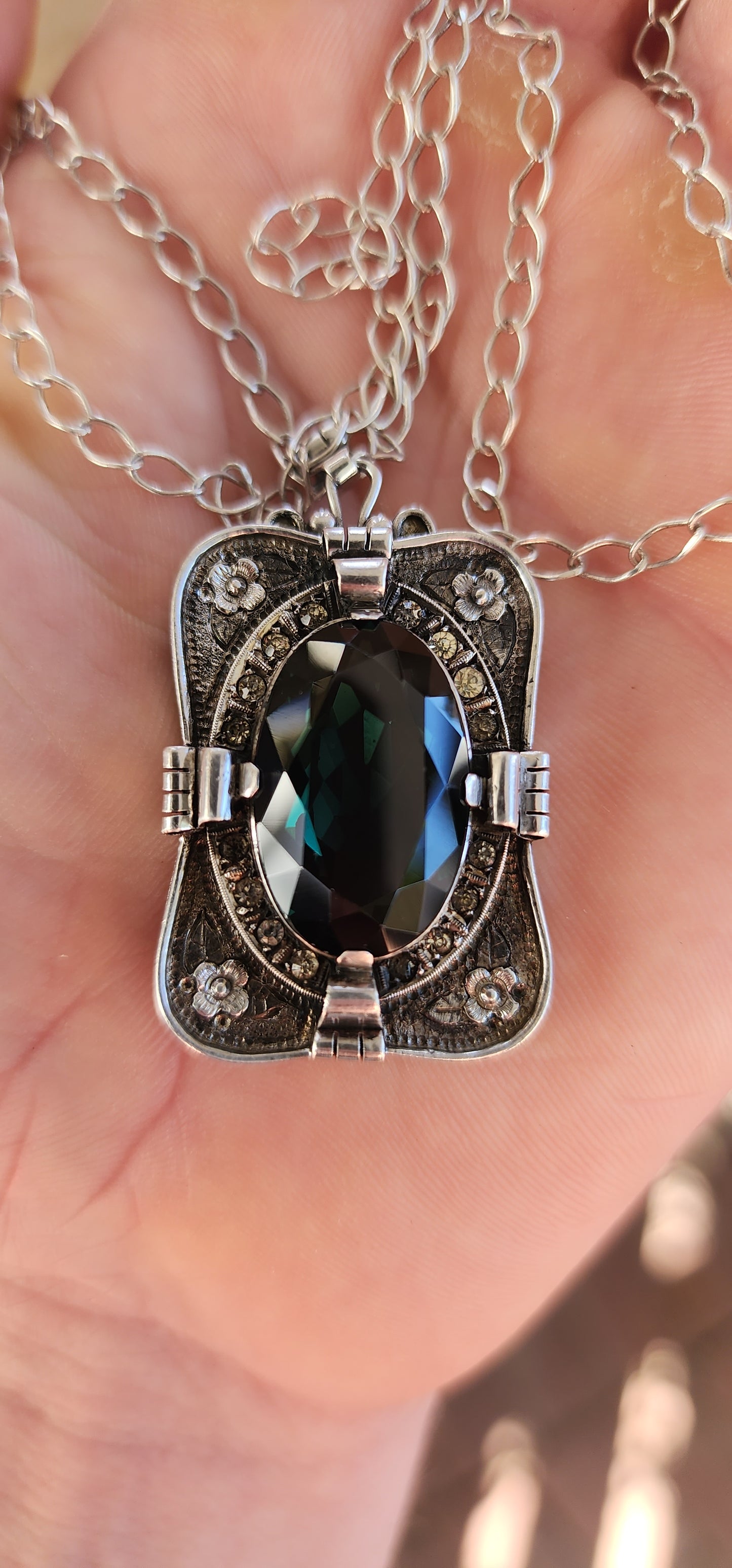 A magnificent step-back into the golden age of glamour, this rare and generous Art Deco pendant is a true showpiece—richly detailed, architecturally sculpted, and brimming with Old-World mystique.