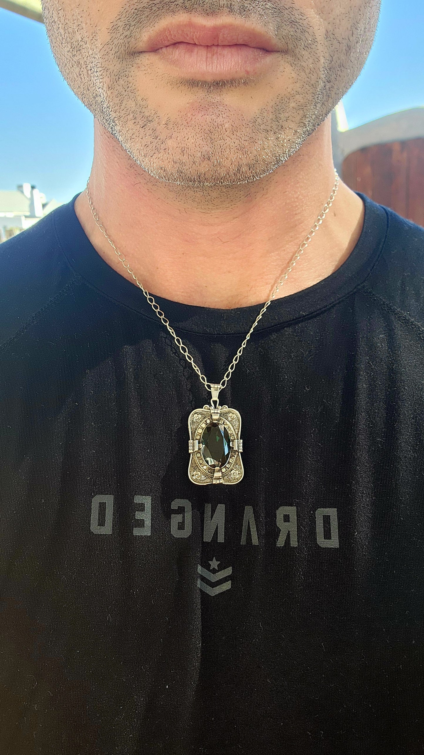 A magnificent step-back into the golden age of glamour, this rare and generous Art Deco pendant is a true showpiece—richly detailed, architecturally sculpted, and brimming with Old-World mystique.
