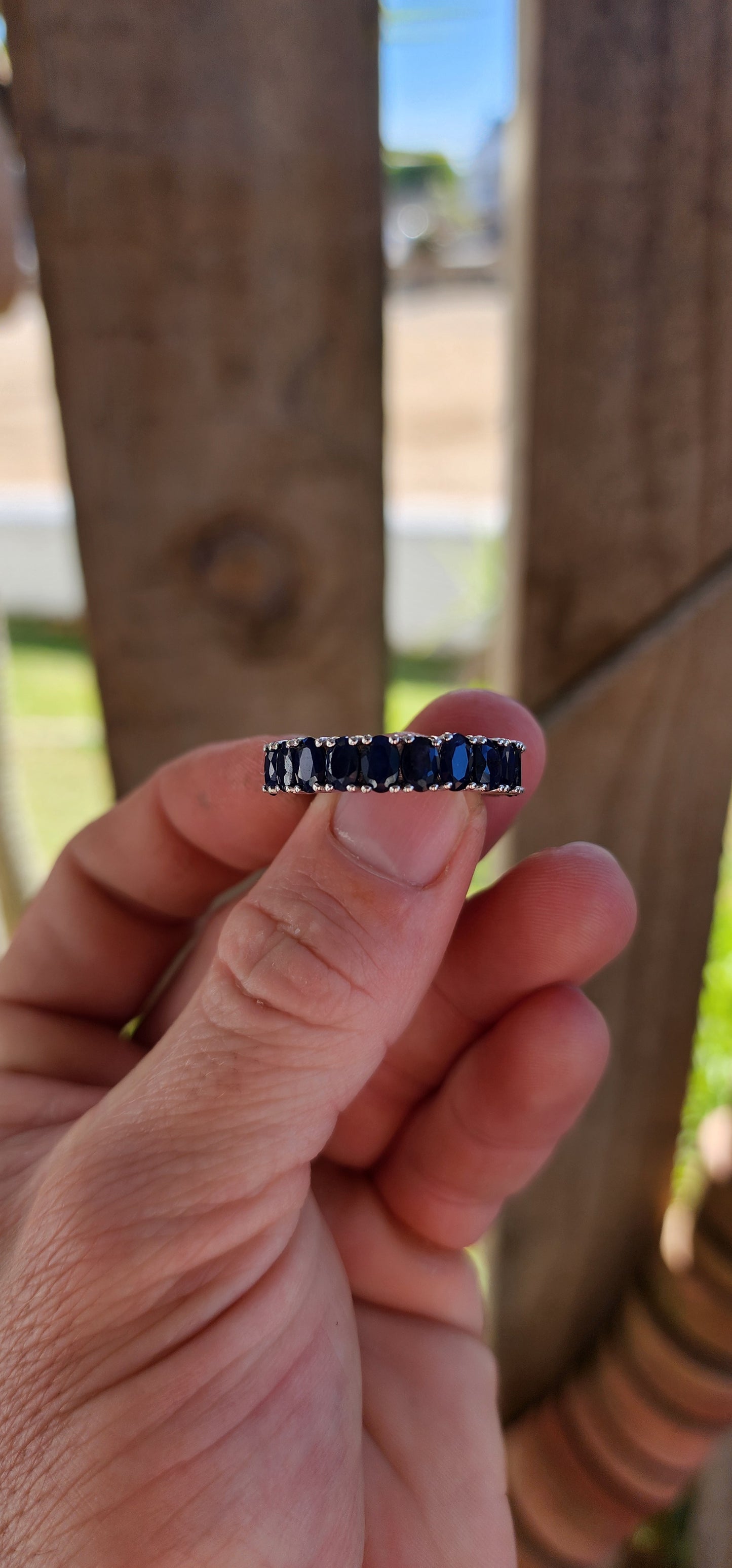 This breathtaking full-eternity ring is a deep-blue dream, set with 21 richly saturated oval-cut sapphires arranged in an unbroken circle of twilight brilliance.