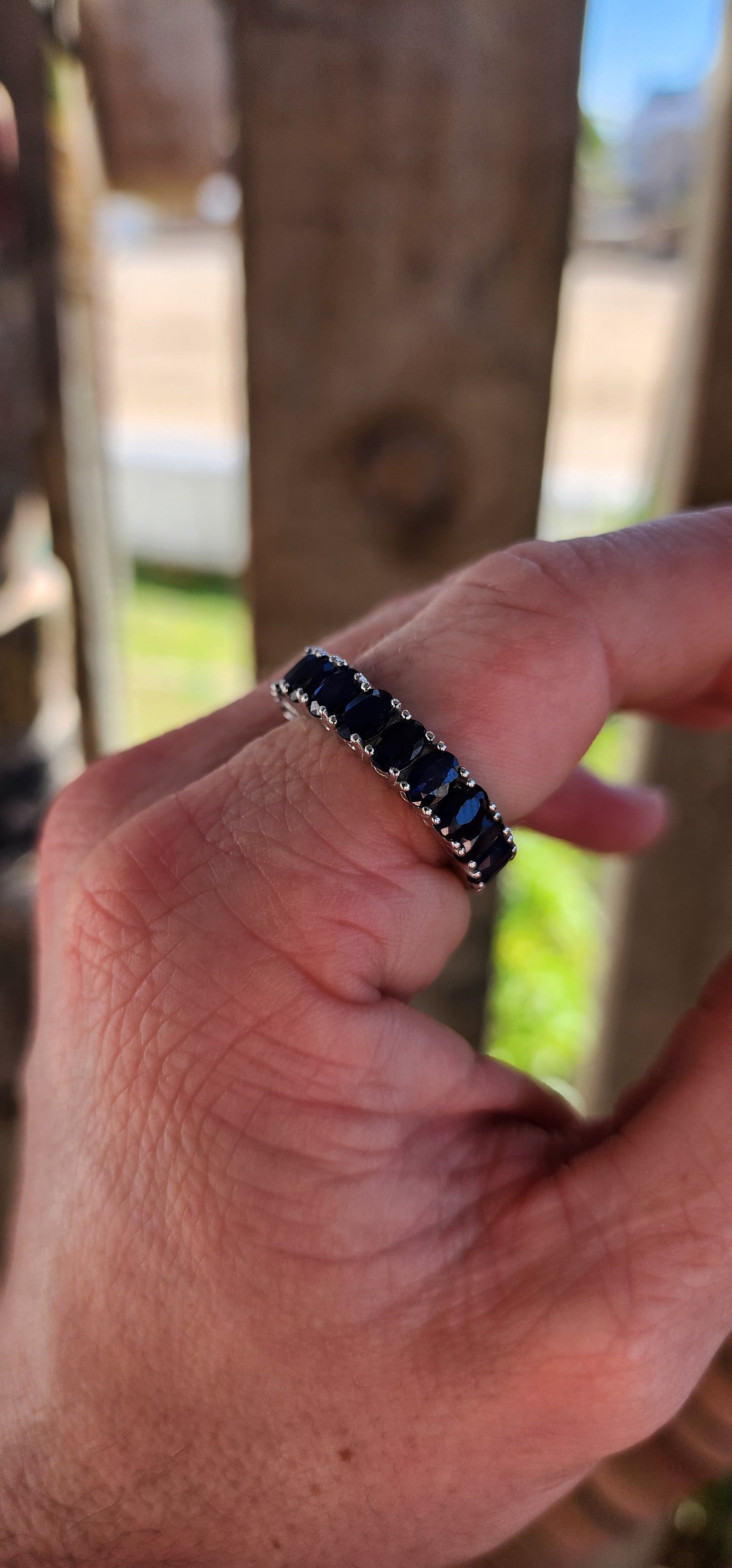 This breathtaking full-eternity ring is a deep-blue dream, set with 21 richly saturated oval-cut sapphires arranged in an unbroken circle of twilight brilliance.
