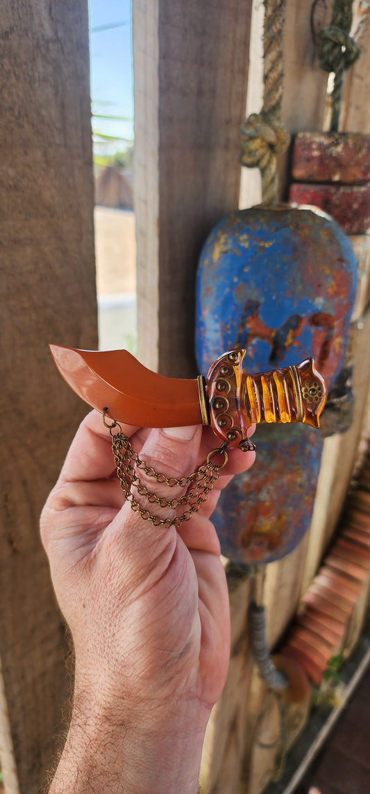 Marvelous and oversized Art Deco–era bakelite novelty brooch, exquisitely carved in the exotic form of a Persian dagger (khanjar)