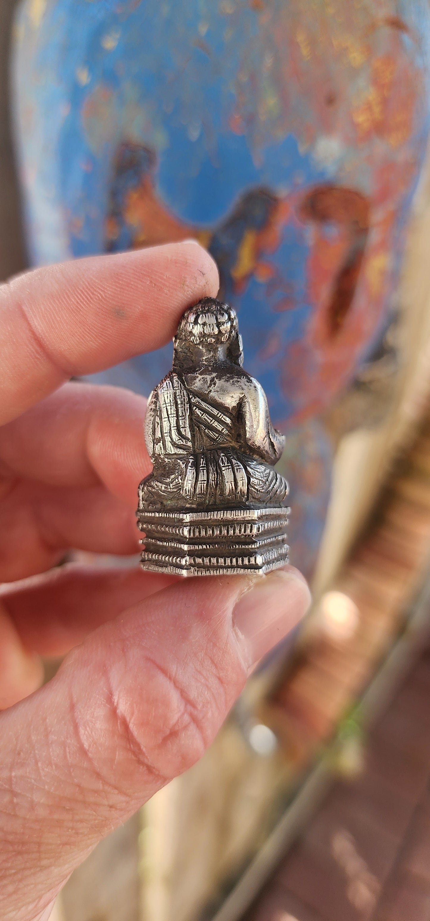An impressive and wonderfully weighty antique miniature traveling Buddha, finely cast in solid sterling silver.