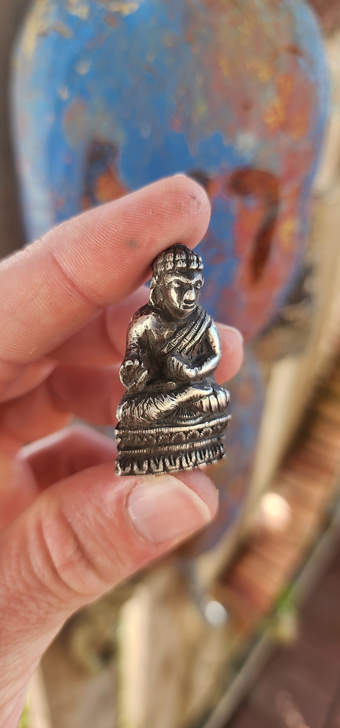 An impressive and wonderfully weighty antique miniature traveling Buddha, finely cast in solid sterling silver.