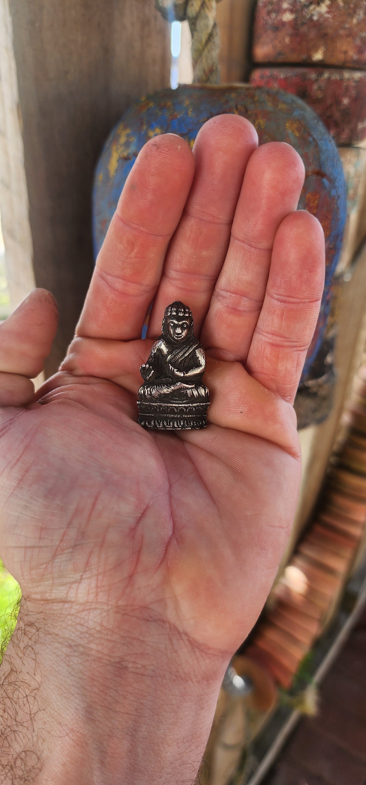 An impressive and wonderfully weighty antique miniature traveling Buddha, finely cast in solid sterling silver.
