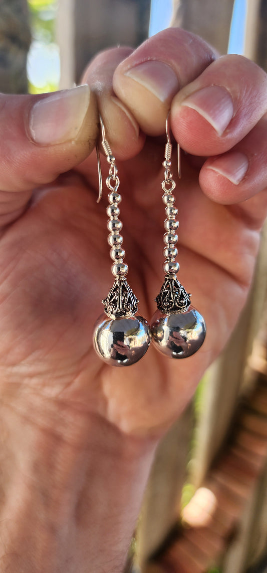 These magnificent sterling silver Balinese drop earrings are here to swing, shimmer, and steal the scene!