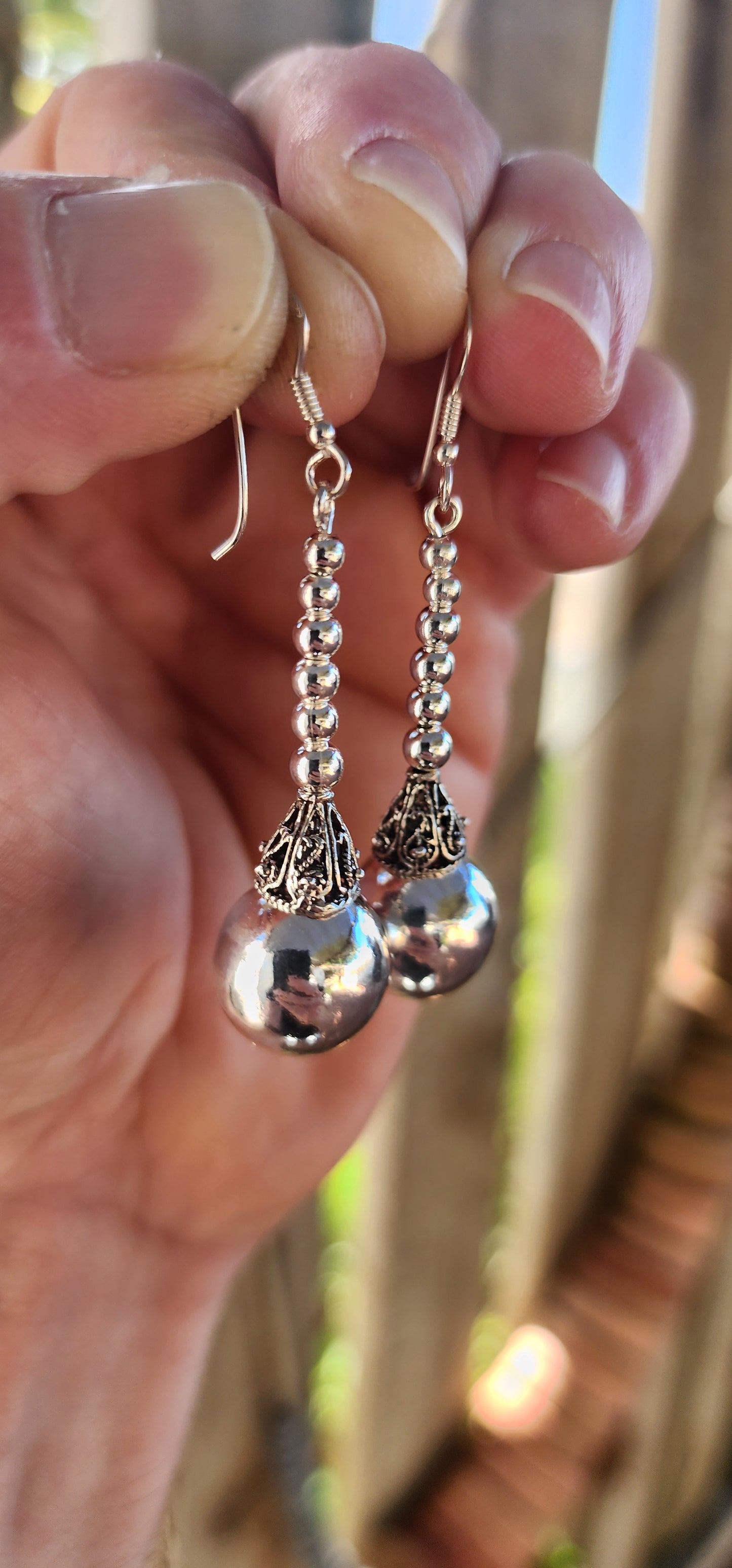 These magnificent sterling silver Balinese drop earrings are here to swing, shimmer, and steal the scene!