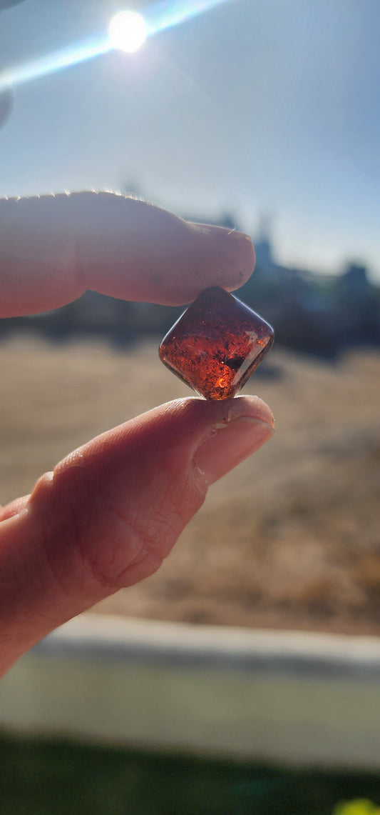 Behold this generous, dark burnt-orange tourmaline cabochon, masterfully shaped in the coveted sugar-loaf cut—a style treasured since ancient times for its softly domed peak and rounded geometric form.