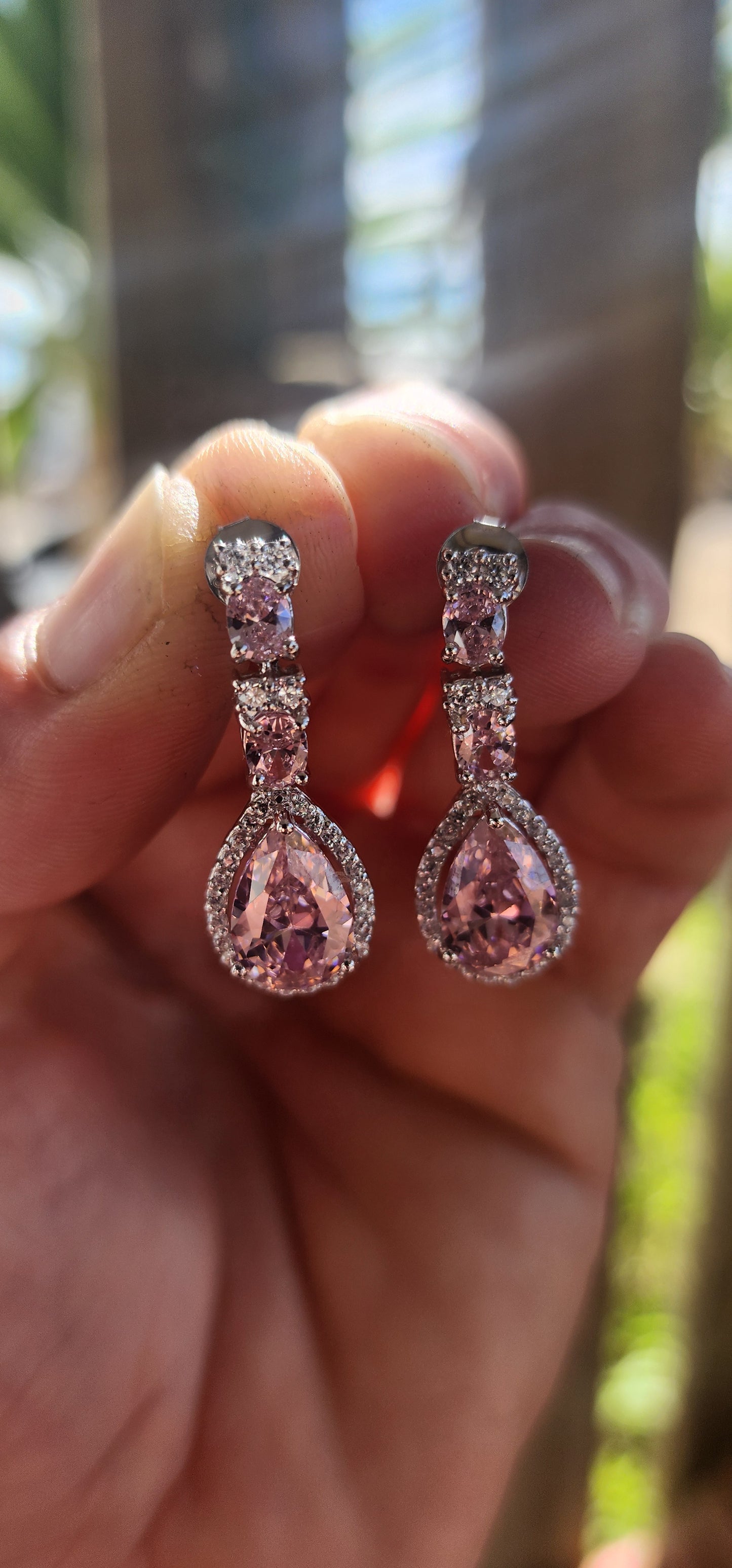 Crafted in solid sterling silver, these drop earrings are a dazzling celebration of all things feminine, flirty, and fabulously glamorous.