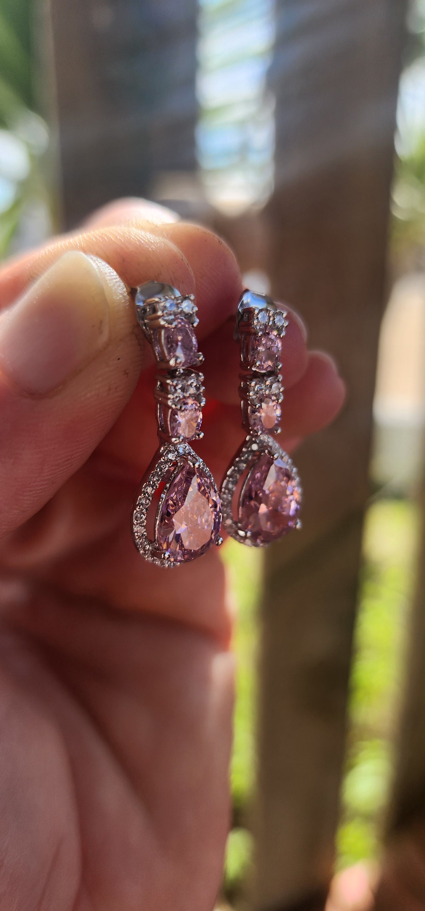 Crafted in solid sterling silver, these drop earrings are a dazzling celebration of all things feminine, flirty, and fabulously glamorous.