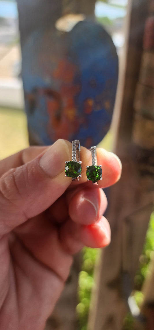 This exquisite pair of sterling silver Tsavorite earrings delivers a burst of rare, electric colour with every turn of the head
