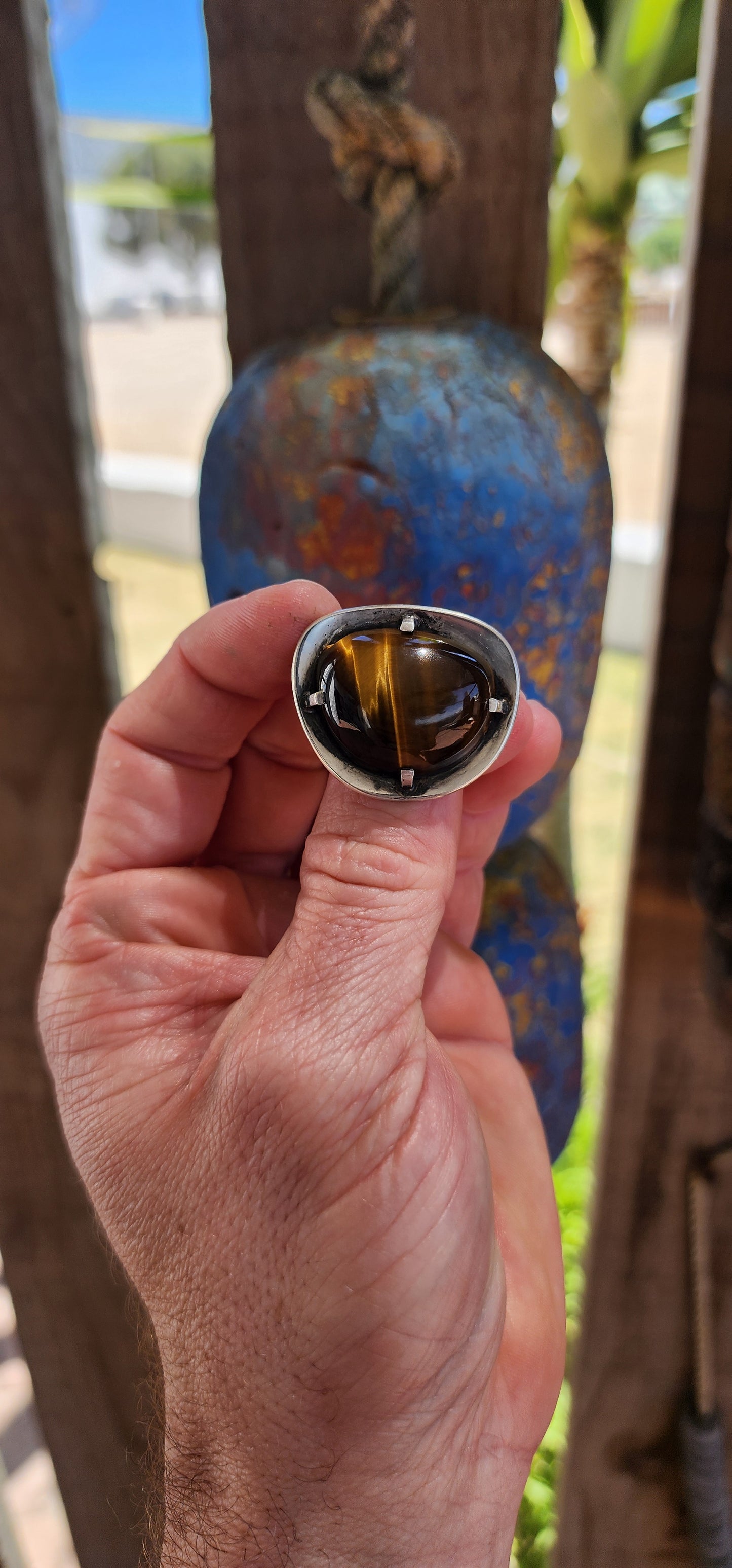 A bold and beautifully crafted vintage modernist brooch dating to the circa 1970s, this striking piece showcases a generously sized, high-domed Tiger’s Eye cabochon set in hand-crafted sterling silver.