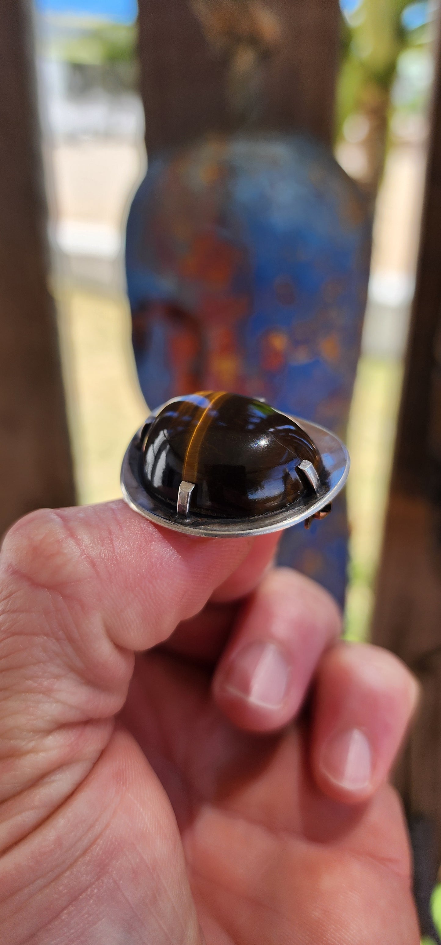 A bold and beautifully crafted vintage modernist brooch dating to the circa 1970s, this striking piece showcases a generously sized, high-domed Tiger’s Eye cabochon set in hand-crafted sterling silver.