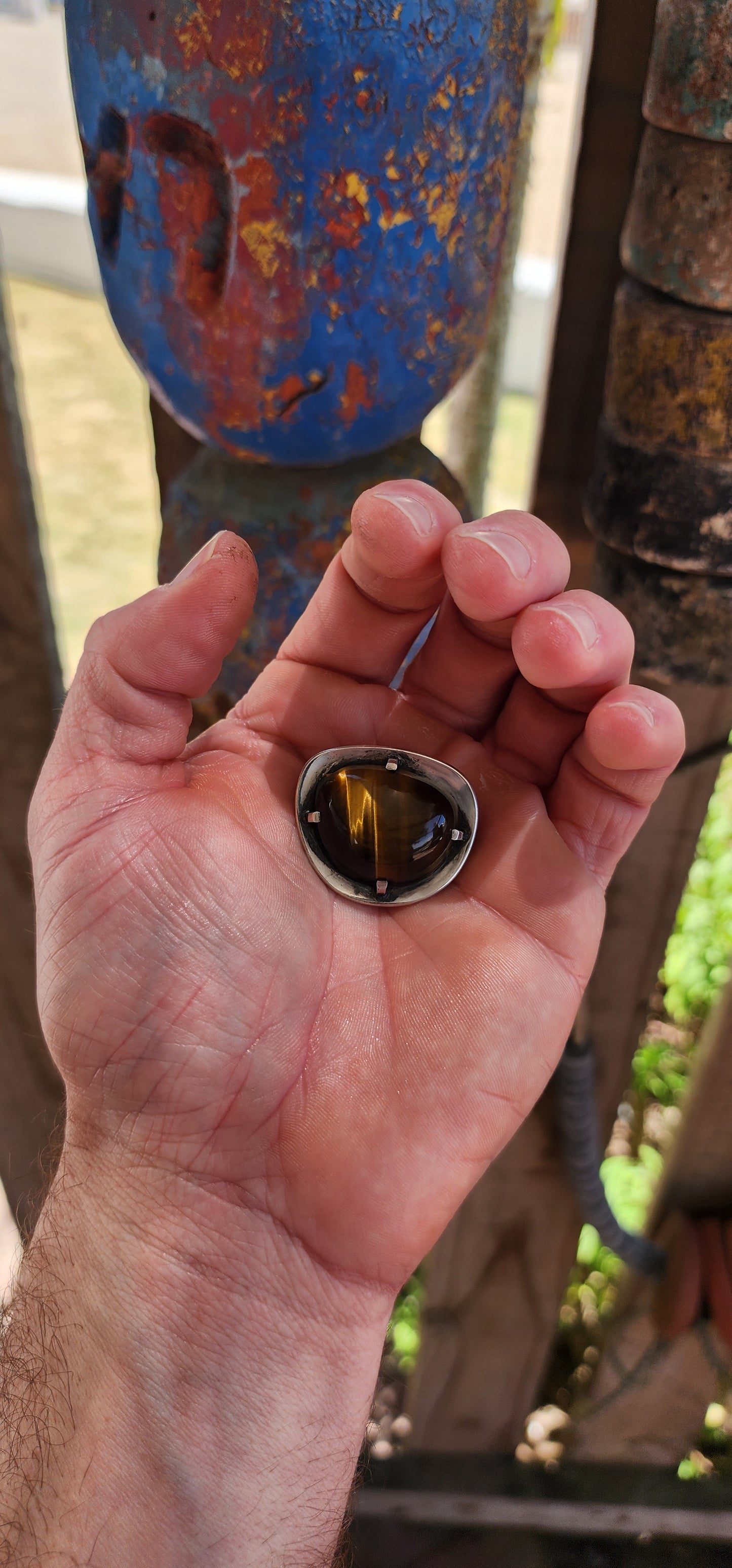 A bold and beautifully crafted vintage modernist brooch dating to the circa 1970s, this striking piece showcases a generously sized, high-domed Tiger’s Eye cabochon set in hand-crafted sterling silver.
