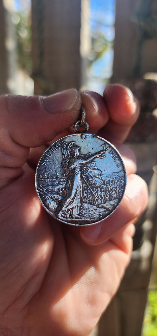 A breathtaking slice of British–South African military heritage, now transformed into a bold, wearable treasure for the modern collector. This authentic Second Boer War–era King’s South Africa Medal, crafted in solid sterling silver, dates to circa 1901.