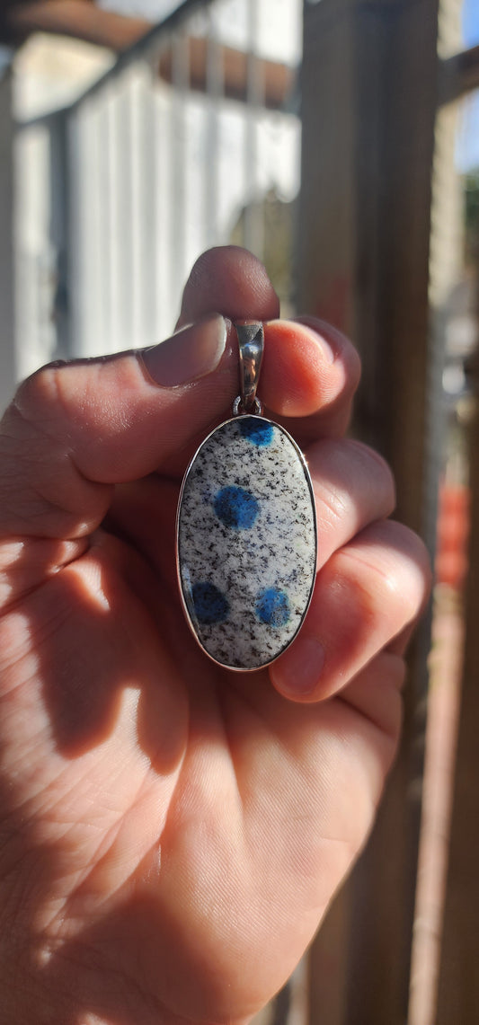 Beautiful sterling silver pendant featuring an oval-shaped rare K2 Jasper cabochon, securely tube-set in a sleek, modern silver frame.