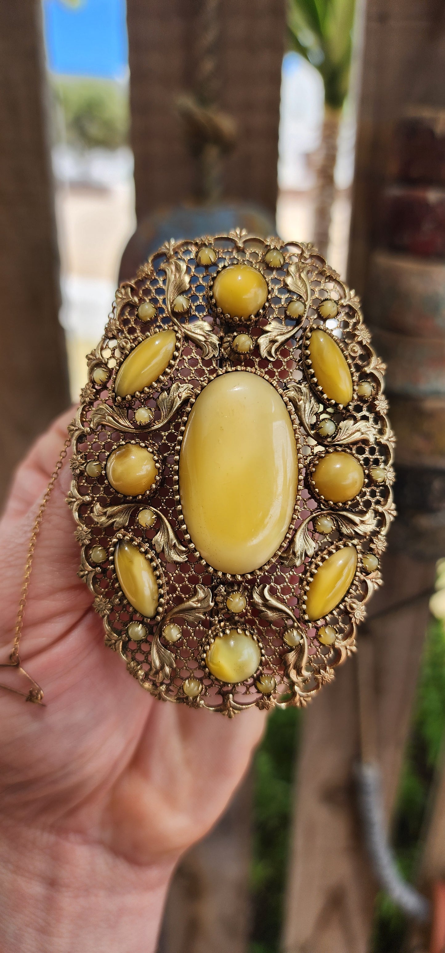 Prepare yourself, because this is not your average Czech brooch — this is a monumental 1920s Art Deco Czech masterpiece, an oversized, opulent explosion of filigree work and uranium satin glass.