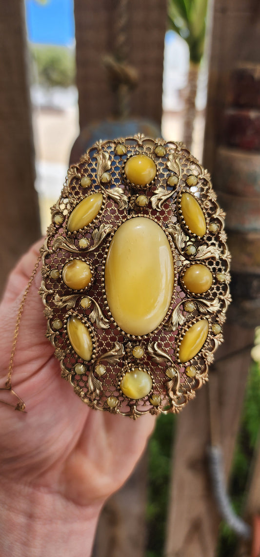 Prepare yourself, because this is not your average Czech brooch — this is a monumental 1920s Art Deco Czech masterpiece, an oversized, opulent explosion of filigree work and uranium satin glass.