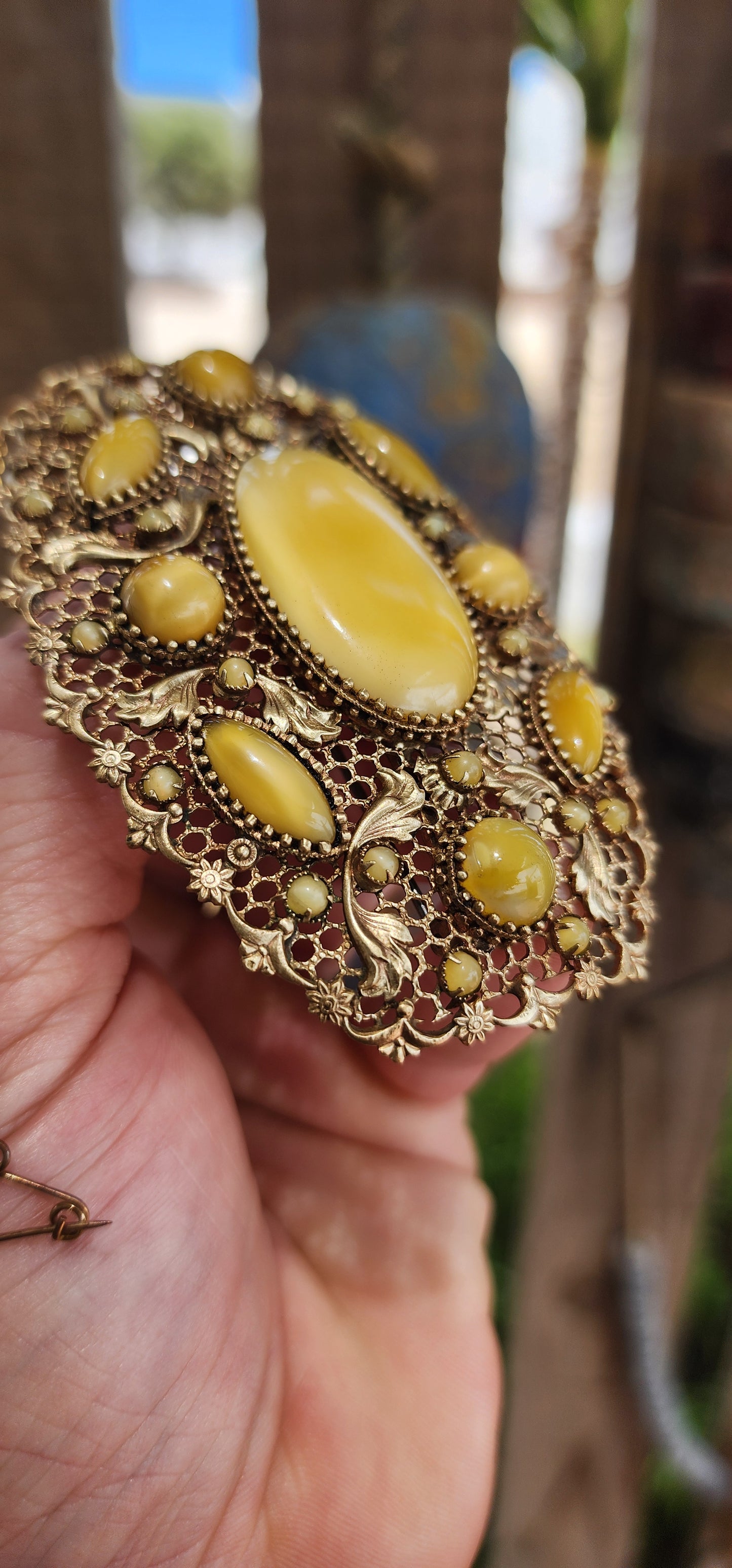 Prepare yourself, because this is not your average Czech brooch — this is a monumental 1920s Art Deco Czech masterpiece, an oversized, opulent explosion of filigree work and uranium satin glass.