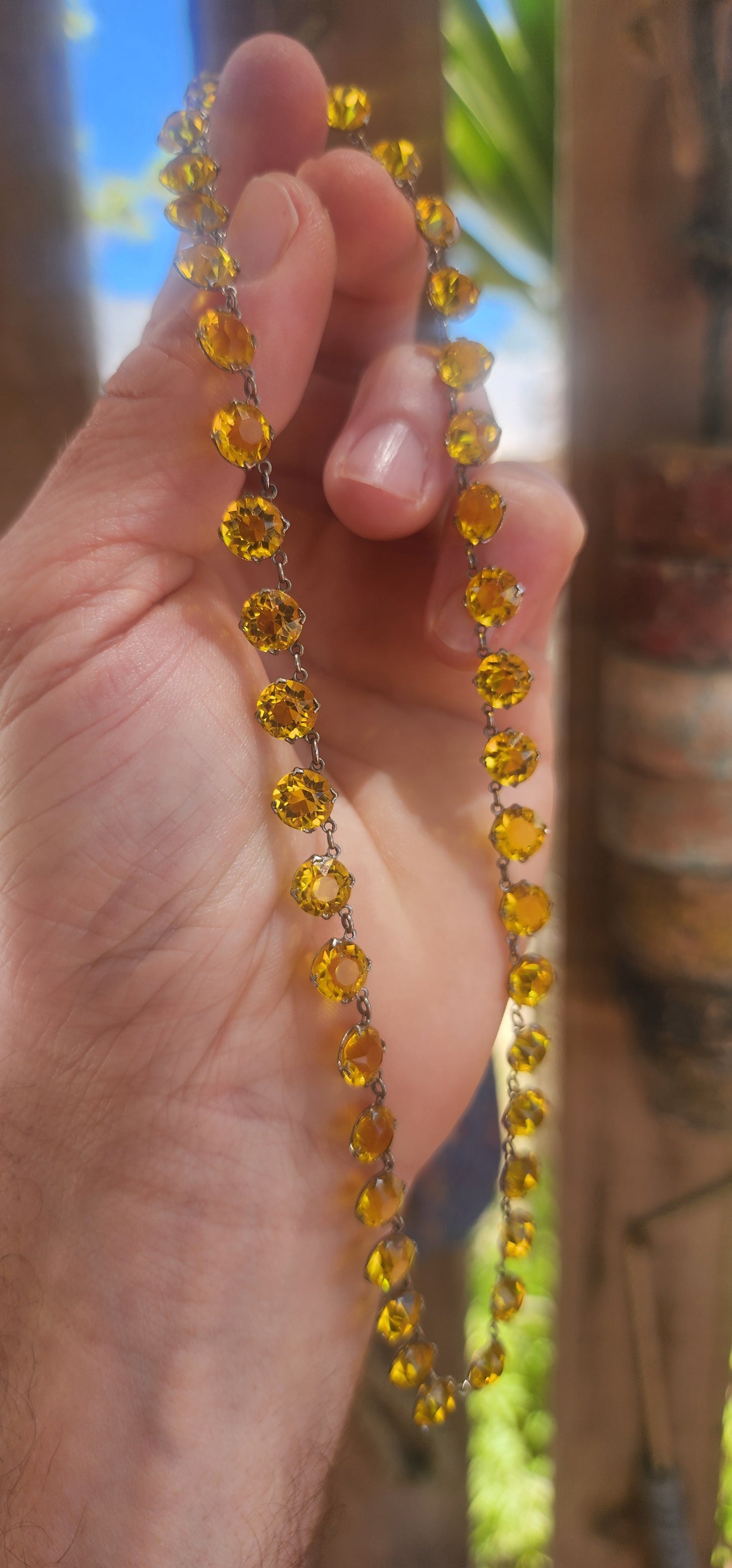 An absolutely spectacular and extremely sought-after Art Deco era circa 1930s sterling silver and yellow paste rivière necklace.