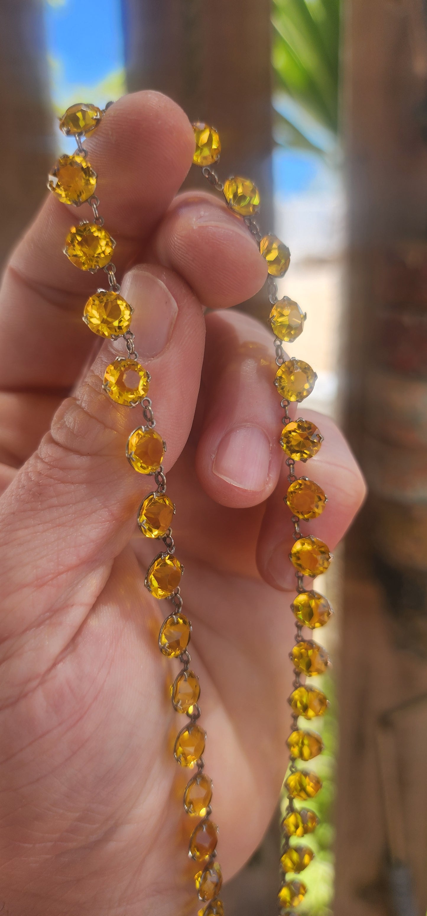 An absolutely spectacular and extremely sought-after Art Deco era circa 1930s sterling silver and yellow paste rivière necklace.