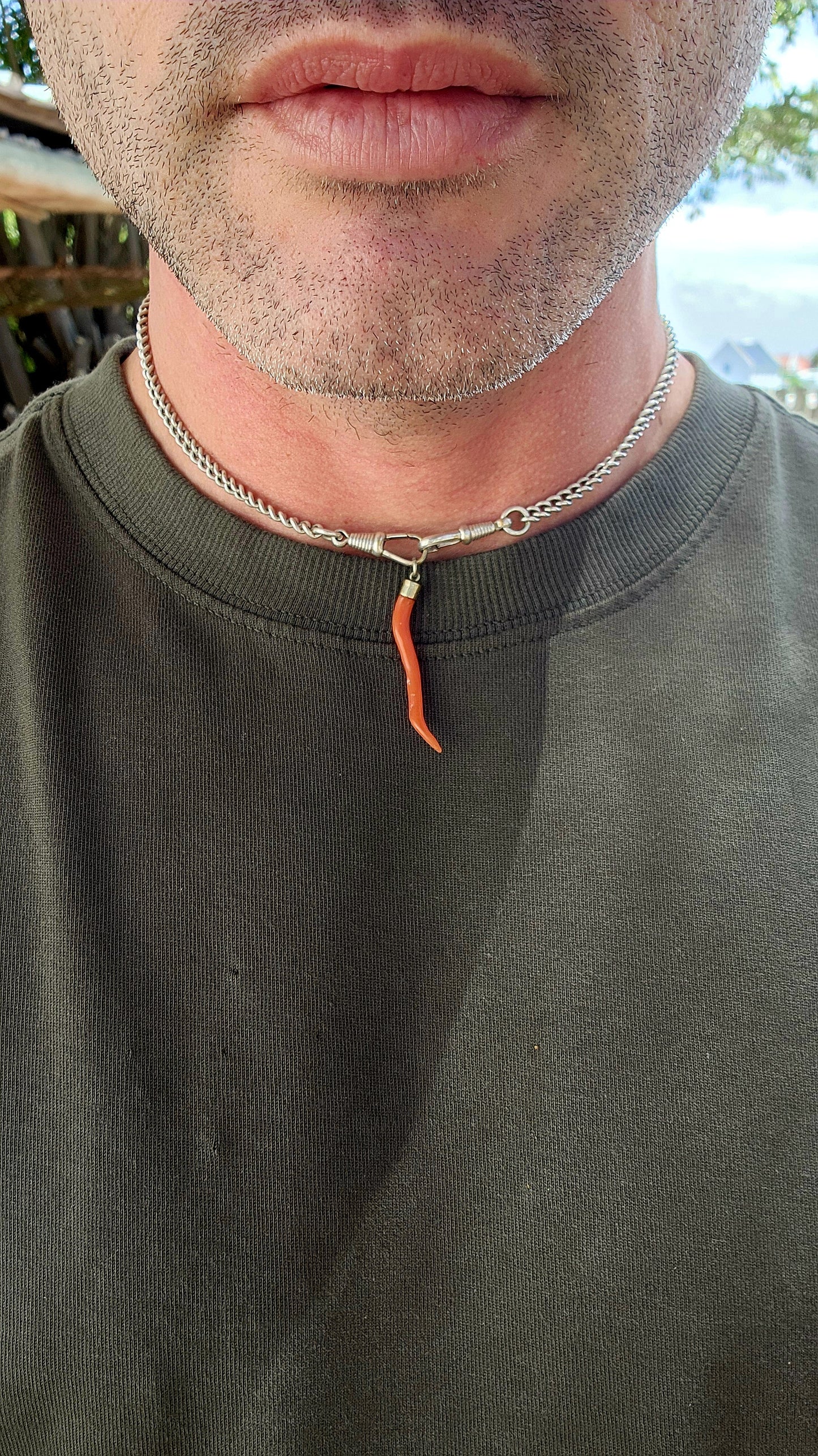 Antique Victorian-era Cornicello pendant, crafted with a sterling silver cap and a beautifully curved piece of genuine Mediterranean red coral.
