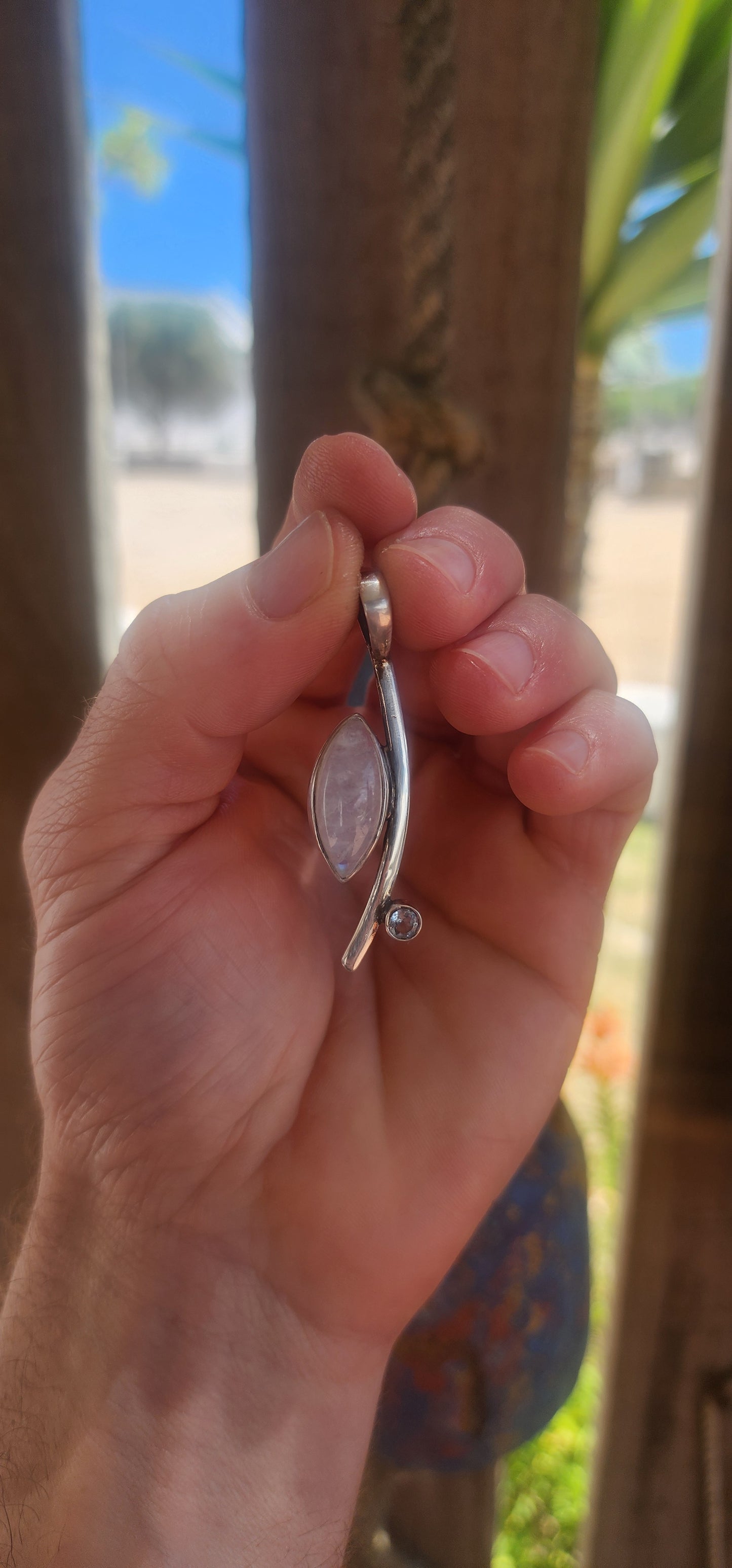 Here we have a sleek, contemporary artisan-made sterling silver pendant that brings all the modernist gallery vibes with a dash of celestial sparkle.
