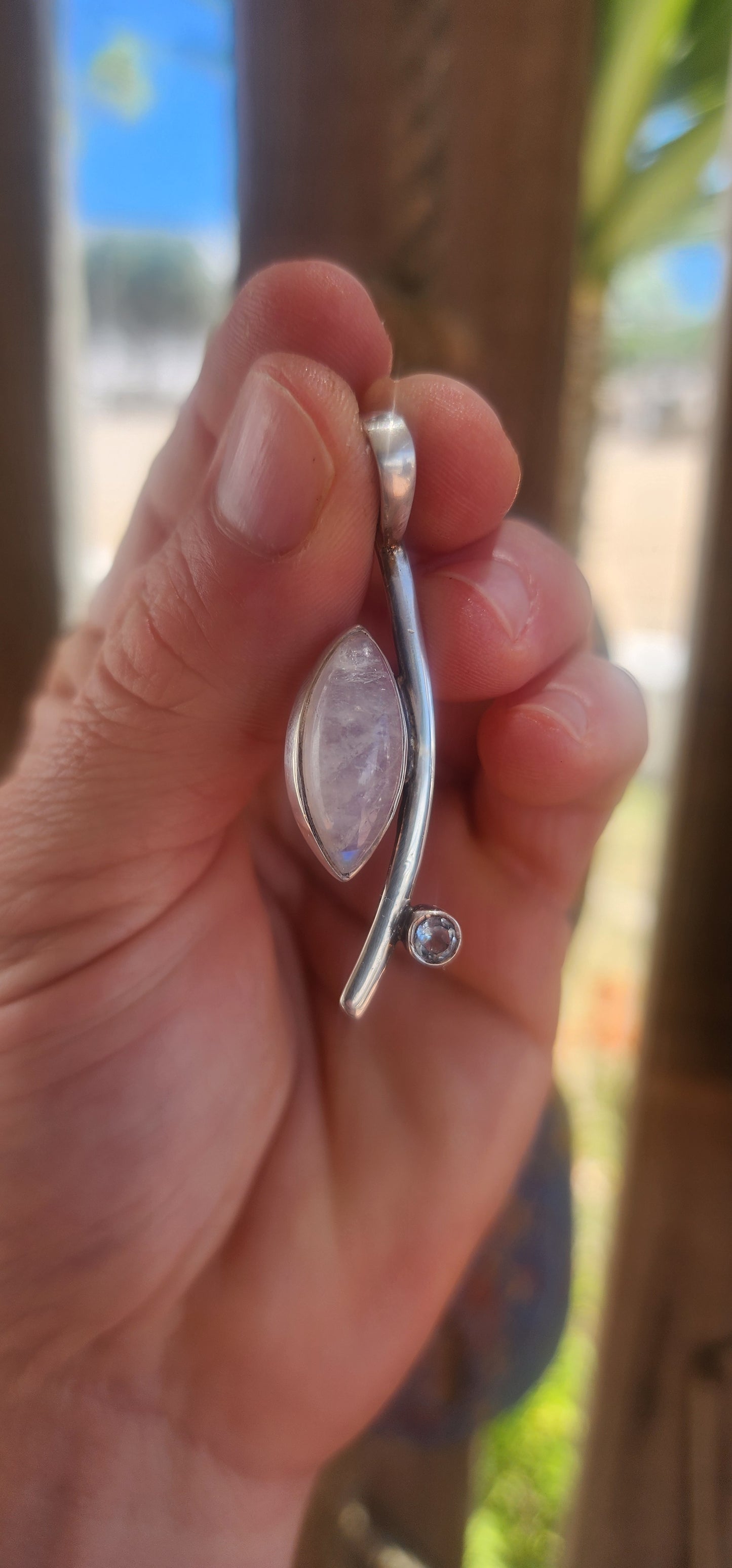 Here we have a sleek, contemporary artisan-made sterling silver pendant that brings all the modernist gallery vibes with a dash of celestial sparkle.