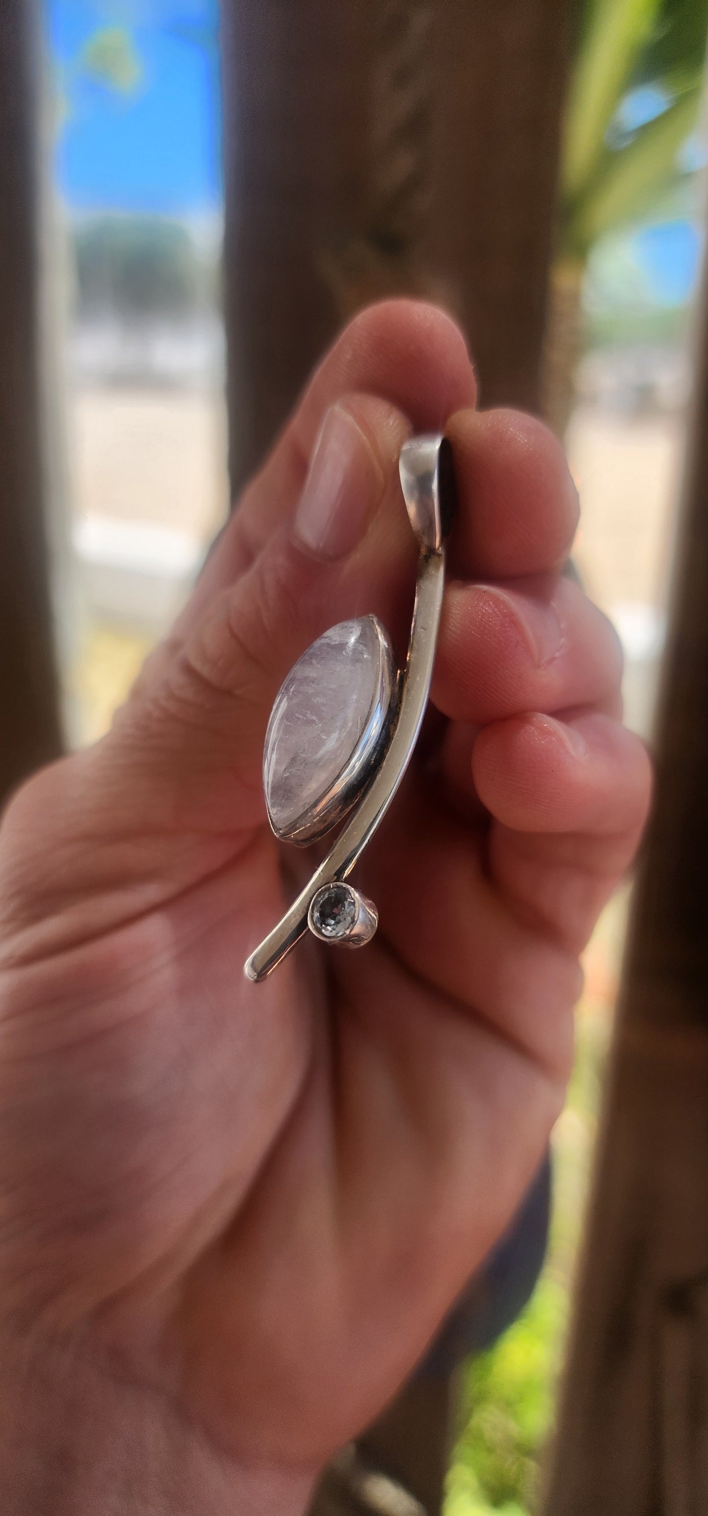 Here we have a sleek, contemporary artisan-made sterling silver pendant that brings all the modernist gallery vibes with a dash of celestial sparkle.