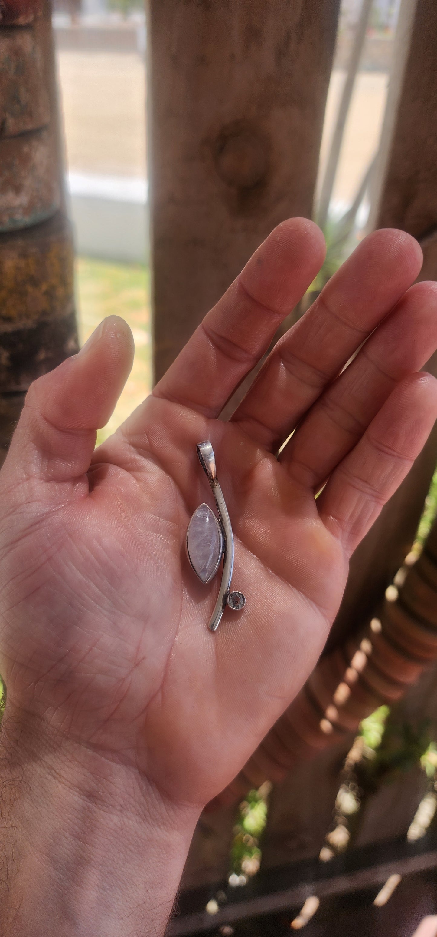 Here we have a sleek, contemporary artisan-made sterling silver pendant that brings all the modernist gallery vibes with a dash of celestial sparkle.