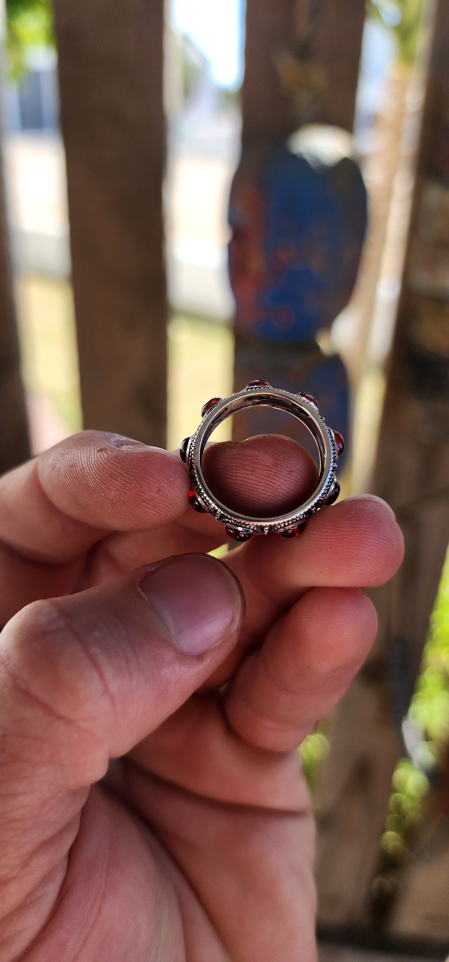 This fabulous unisex sterling silver full eternity ring is pure boho royalty — a band of endless fire wrapped around your finger. Set all the way around the entire circumference are 9 rich oval garnet cabochons.