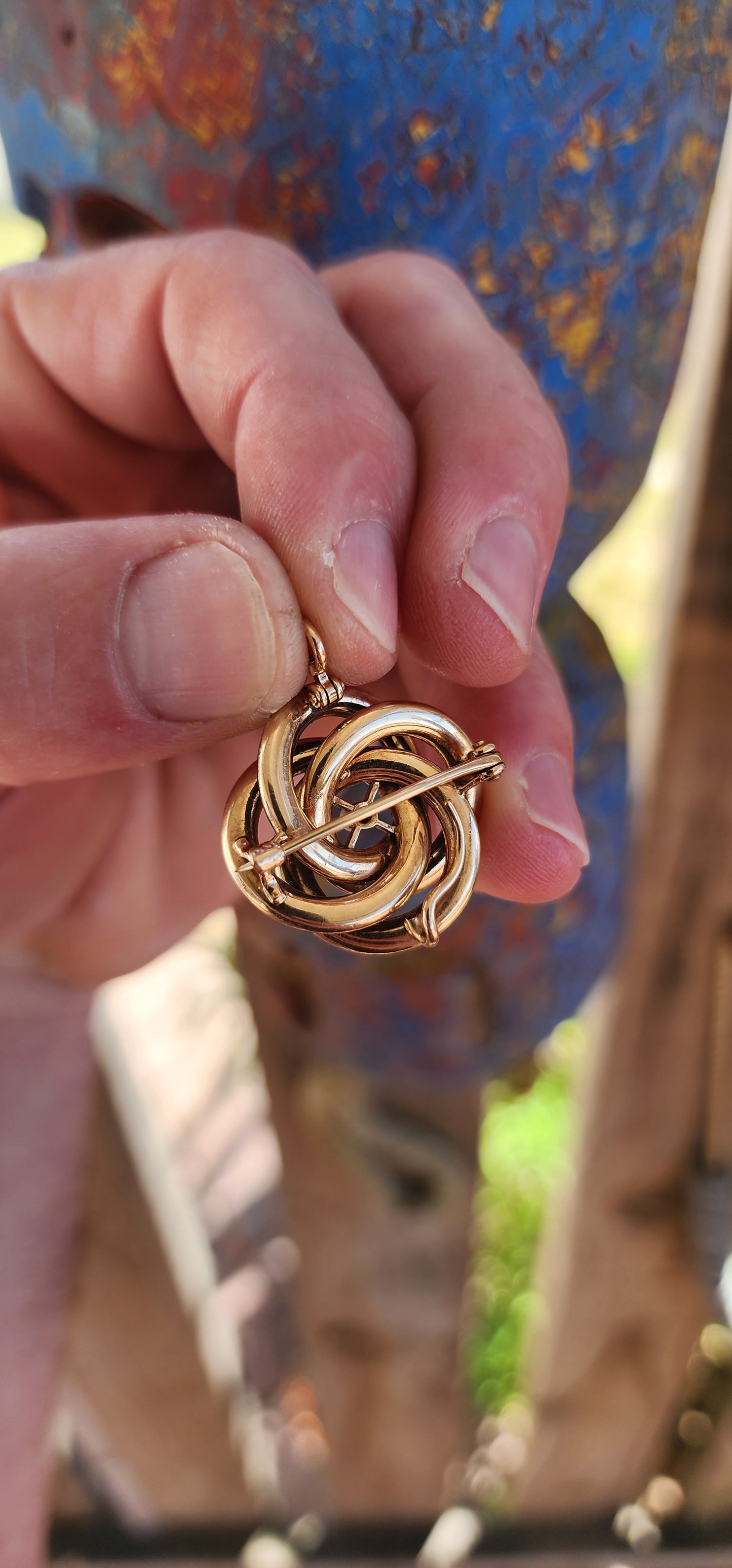 An exceptionally rare Antique Victorian mourning brooch / pendant, crafted in 10ct rosy gold, formed as a deeply symbolic eternity love knot, ebonised to a dramatic inky black enamel and centred with a single, luminous marine cultured pearl.