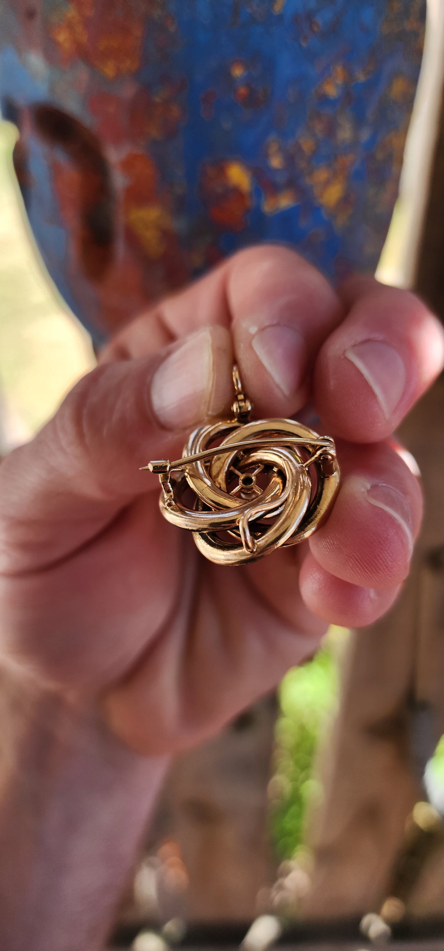 An exceptionally rare Antique Victorian mourning brooch / pendant, crafted in 10ct rosy gold, formed as a deeply symbolic eternity love knot, ebonised to a dramatic inky black enamel and centred with a single, luminous marine cultured pearl.