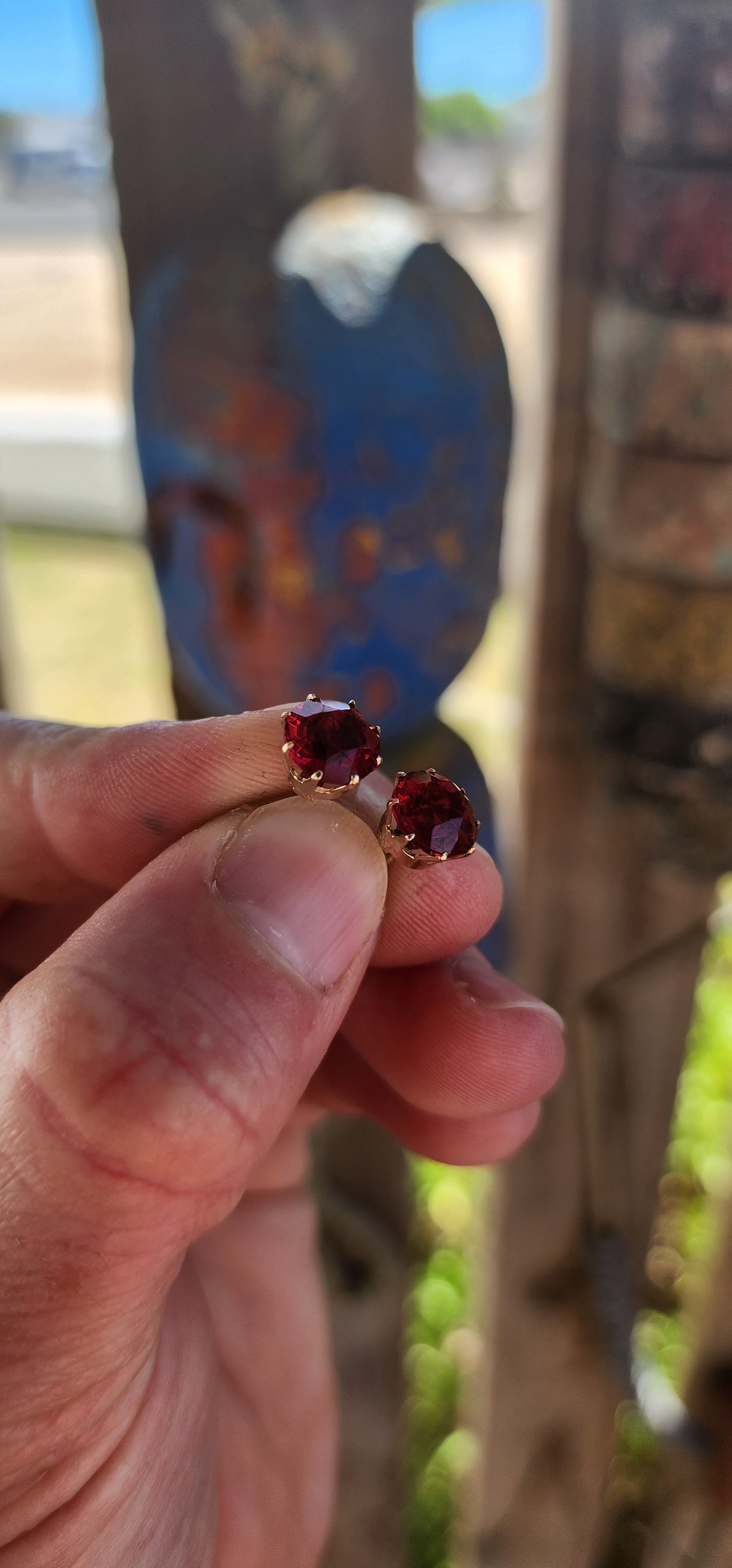 These are an exceptional and increasingly scarce pair of authentic Victorian-era stud earrings, dating to the mid–late 19th century, crafted in 9ct rose gold and set with vivid cranberry-red paste rhinestones of remarkable colour and life.
