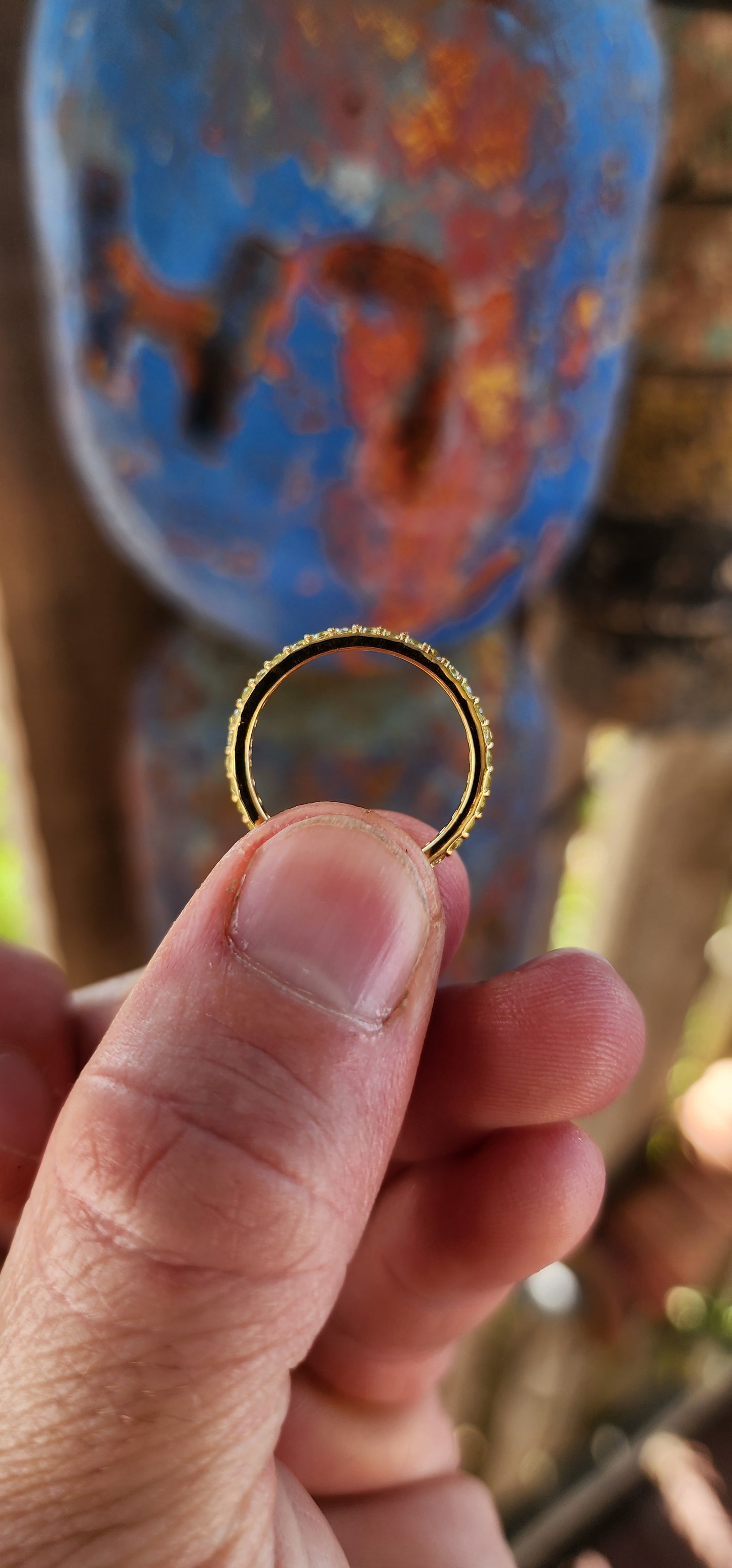A sterling silver full eternity stacking ring, luxuriously plated in 18ct yellow gold and adorned with a continuous circle of sparkling Green Peridots.
