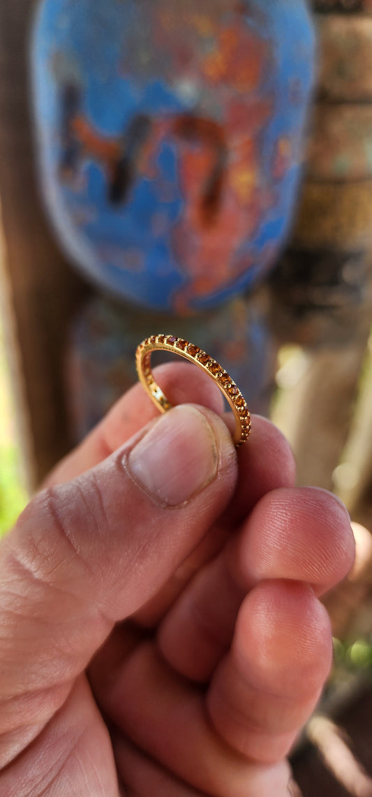 A sterling silver full eternity stacking ring, luxuriously plated in 18ct yellow gold and adorned with a continuous circle of sparkling Orange Madeira Citrine's.