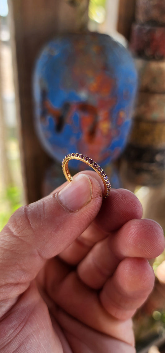 A sterling silver full eternity stacking ring, luxuriously plated in 18ct yellow gold and adorned with a continuous circle of sparkling Purple Amethyst's.