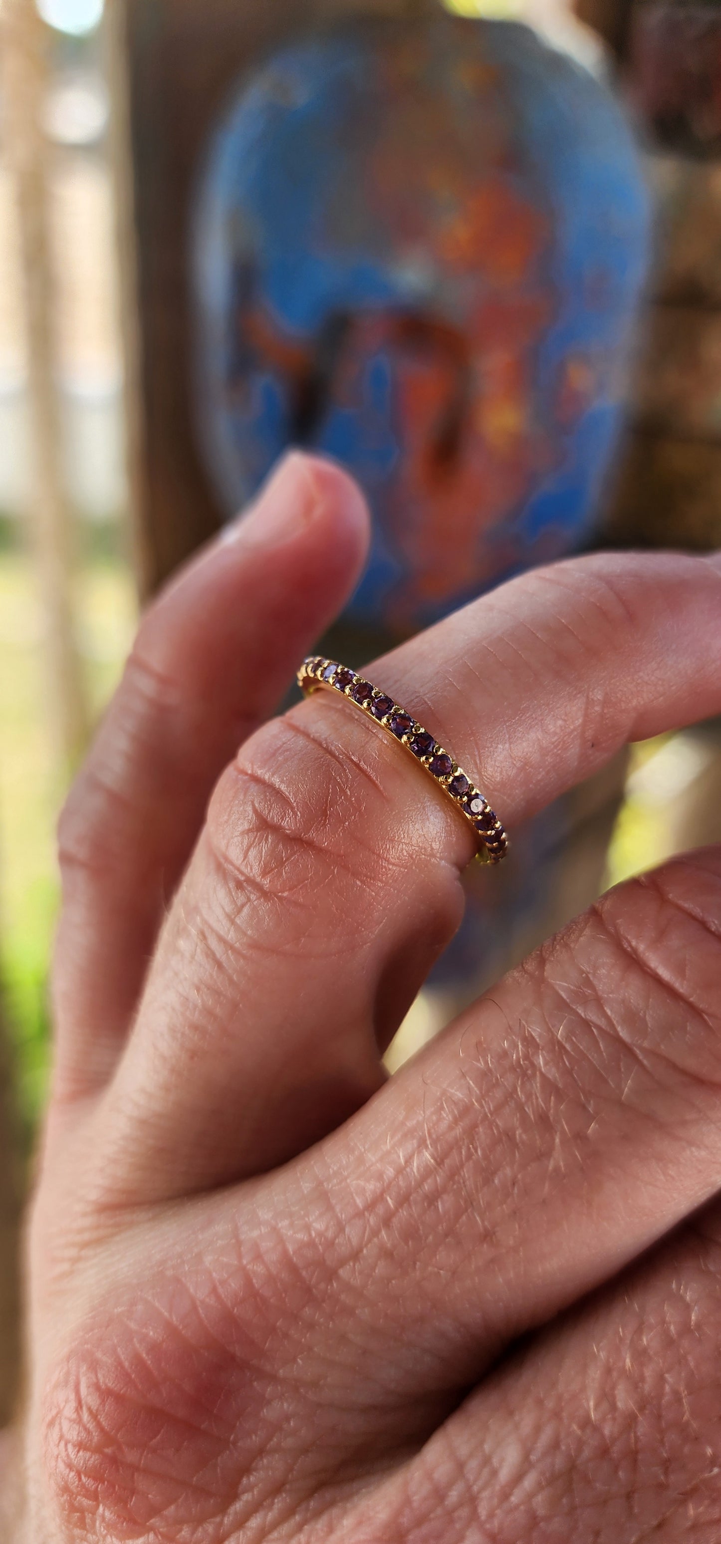 A sterling silver full eternity stacking ring, luxuriously plated in 18ct yellow gold and adorned with a continuous circle of sparkling Purple Amethyst's.