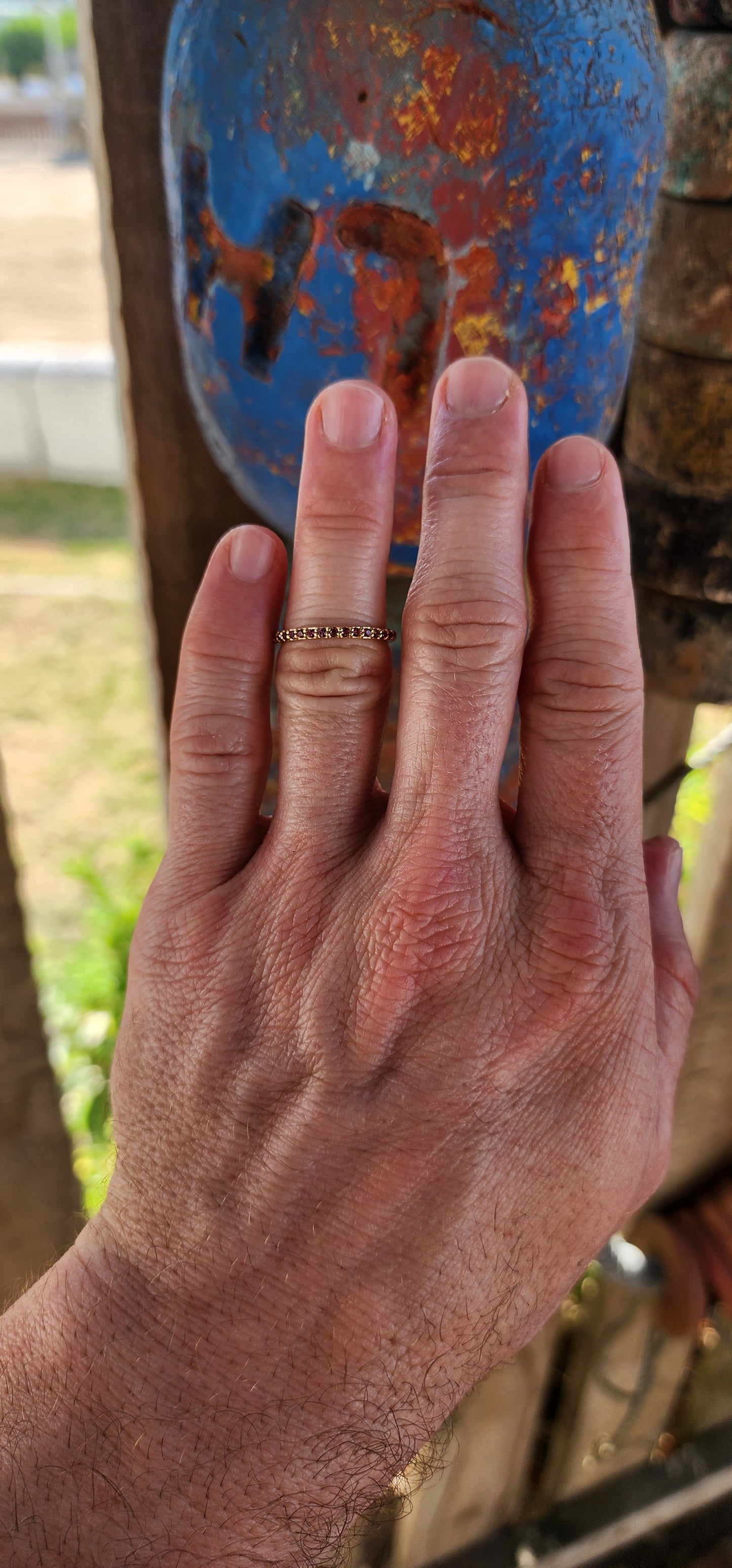 A sterling silver full eternity stacking ring, luxuriously plated in 18ct yellow gold and adorned with a continuous circle of sparkling Purple/Red Rhodolite Garnets.
