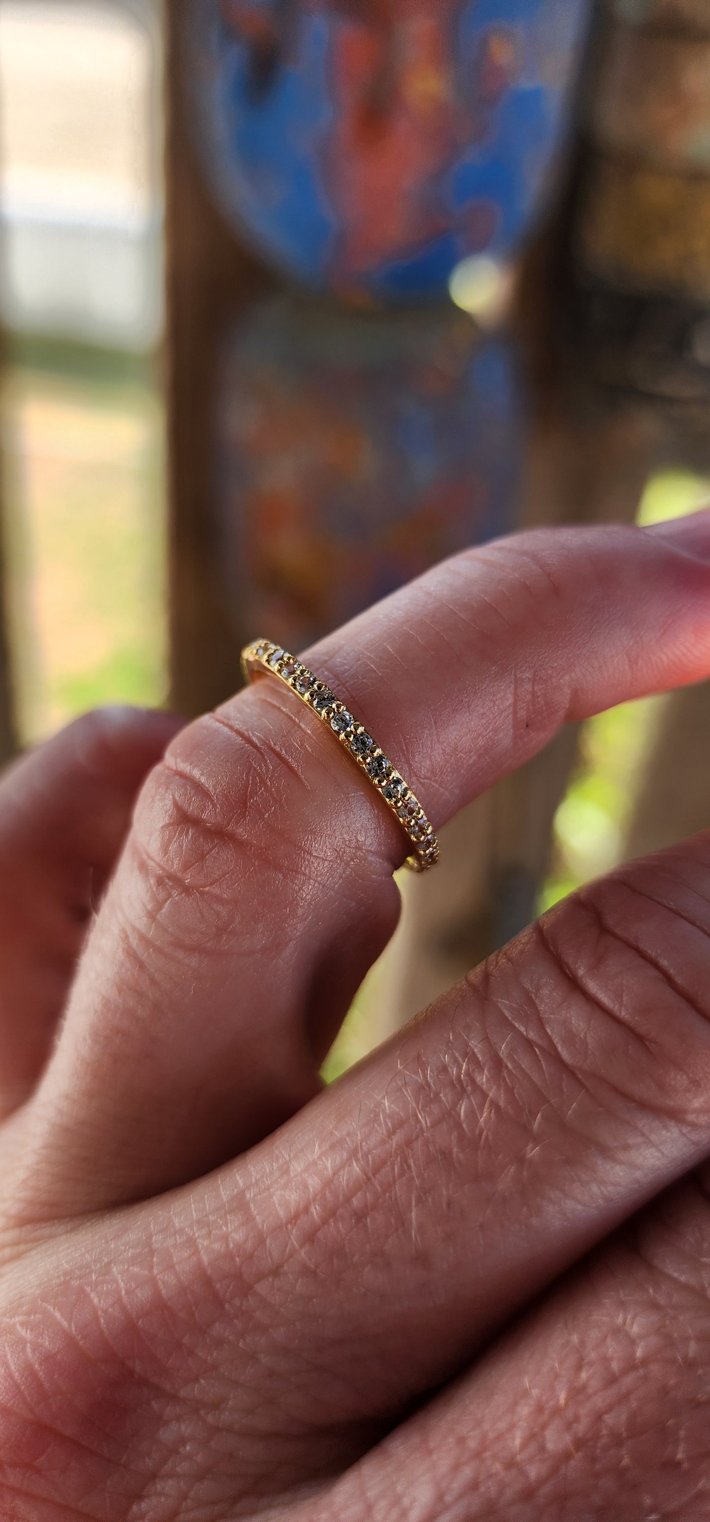 A sterling silver full eternity stacking ring, luxuriously plated in 18ct yellow gold and adorned with a continuous circle of sparkling White Zircons.