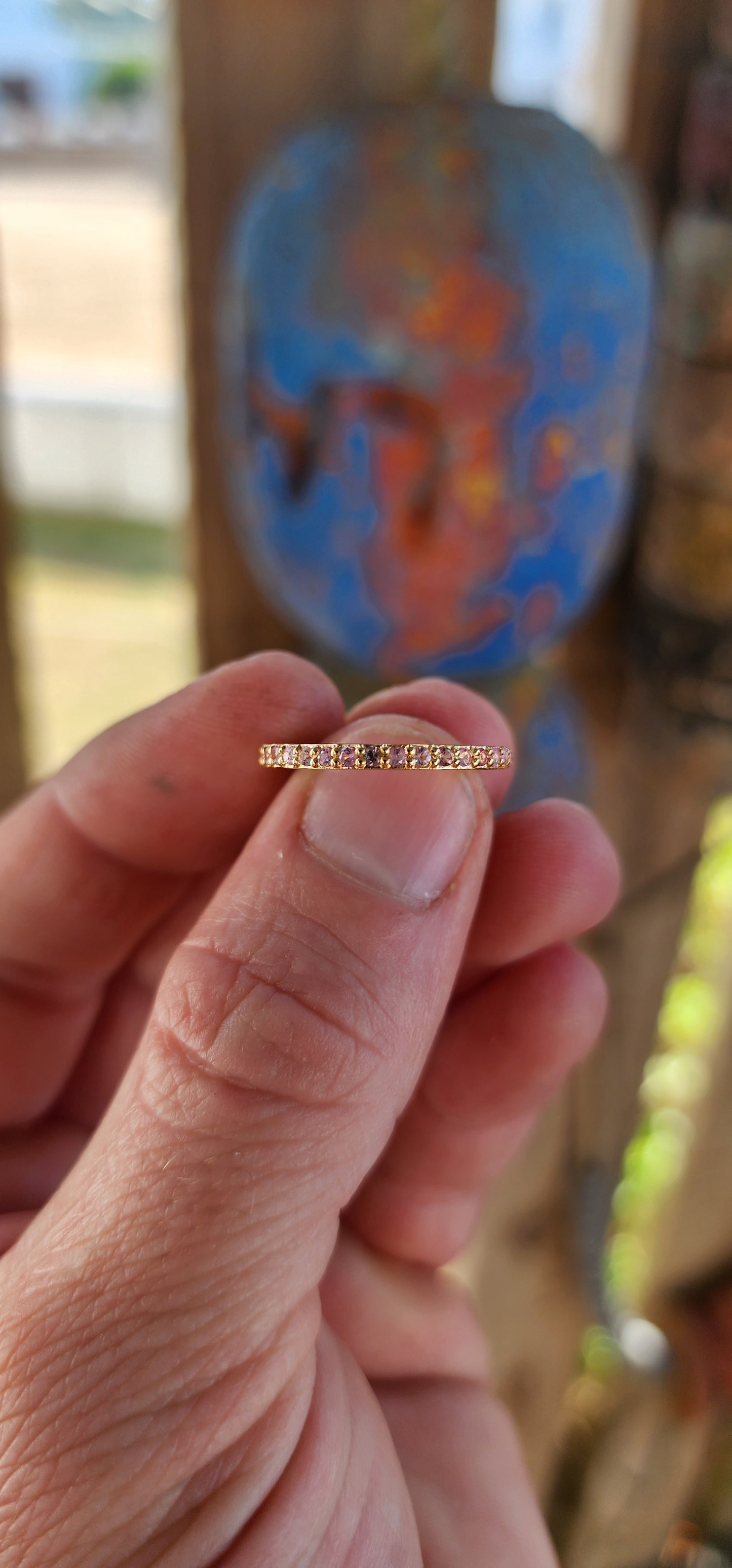 A sterling silver full eternity stacking ring, luxuriously plated in 18ct yellow gold and adorned with a continuous circle of sparkling Pink Sapphires.